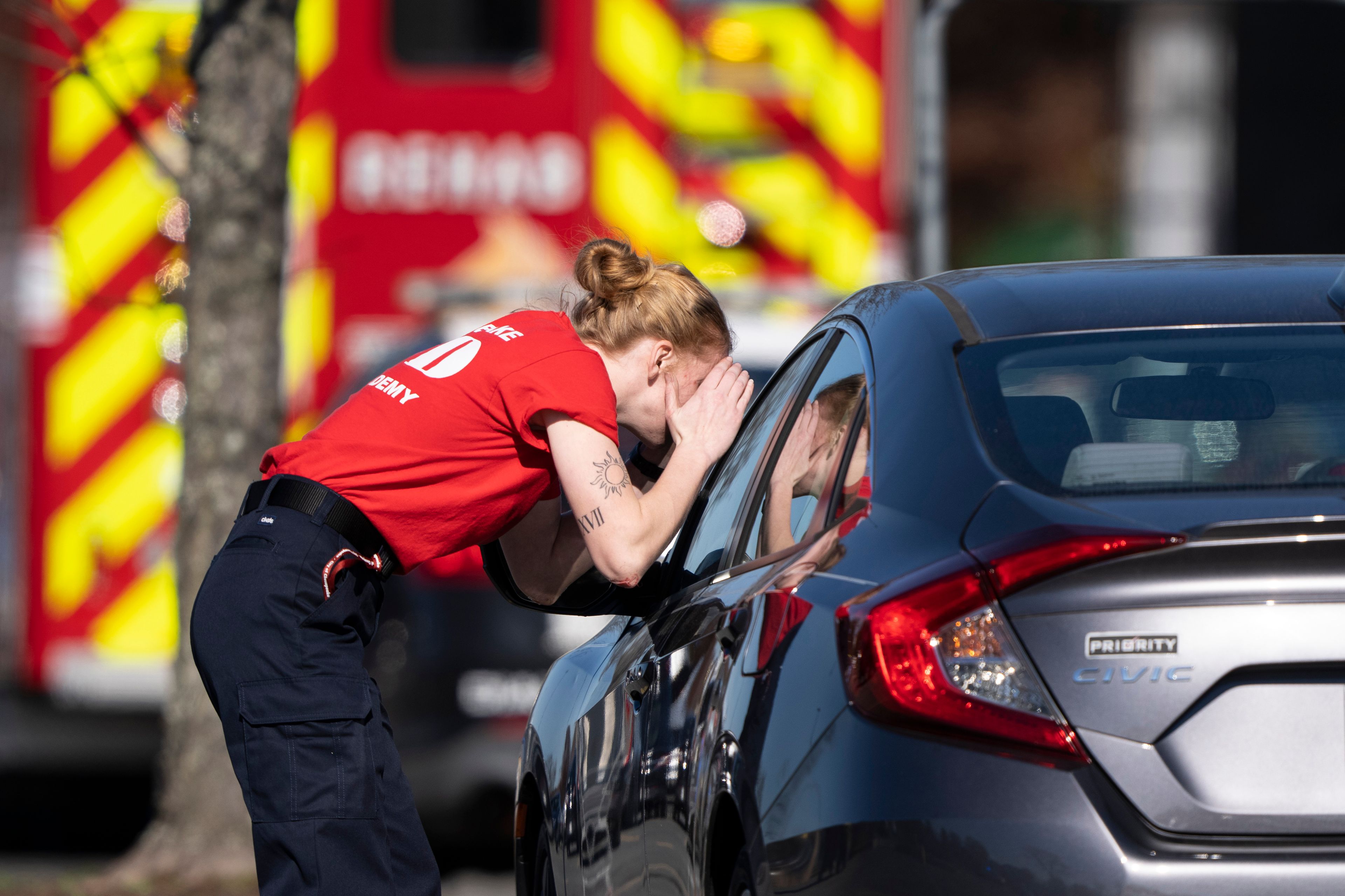 A first responder checks a parked car at the scene of a mass shooting at a Walmart, Wednesday, Nov. 23, 2022, in Chesapeake, Va. A Walmart manager opened fire on fellow employees in the break room of the Virginia store, killing several people in the countryâ€™s second high-profile mass shooting in four days, police and witnesses said Wednesday. (AP Photo/Alex Brandon)