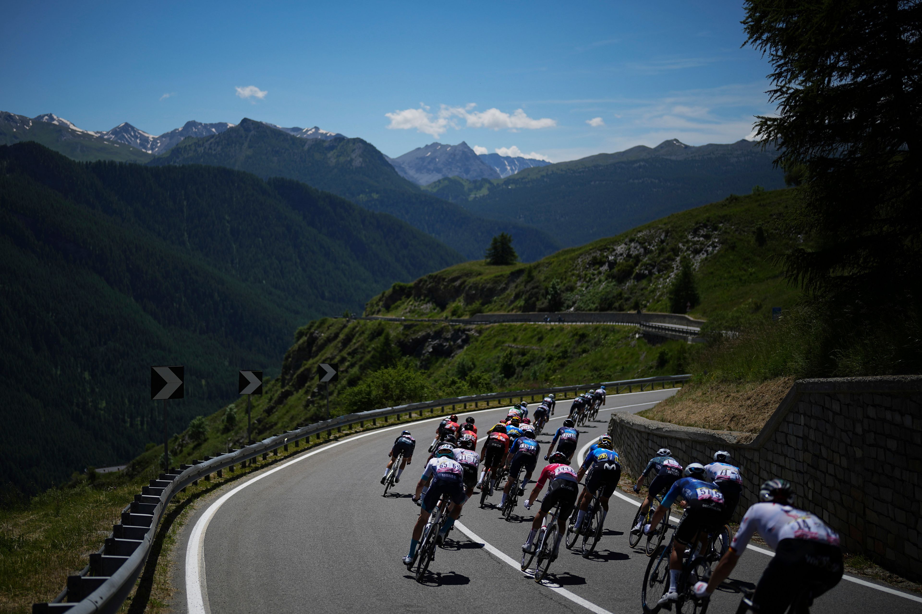 The pack rides during the fourth stage of the Tour de France cycling race over 139.6 kilometers (86.7 miles) with start in Pinerolo, Italy and finish in Valloire, France, Tuesday, July 2, 2024. (AP Photo/Daniel Cole)