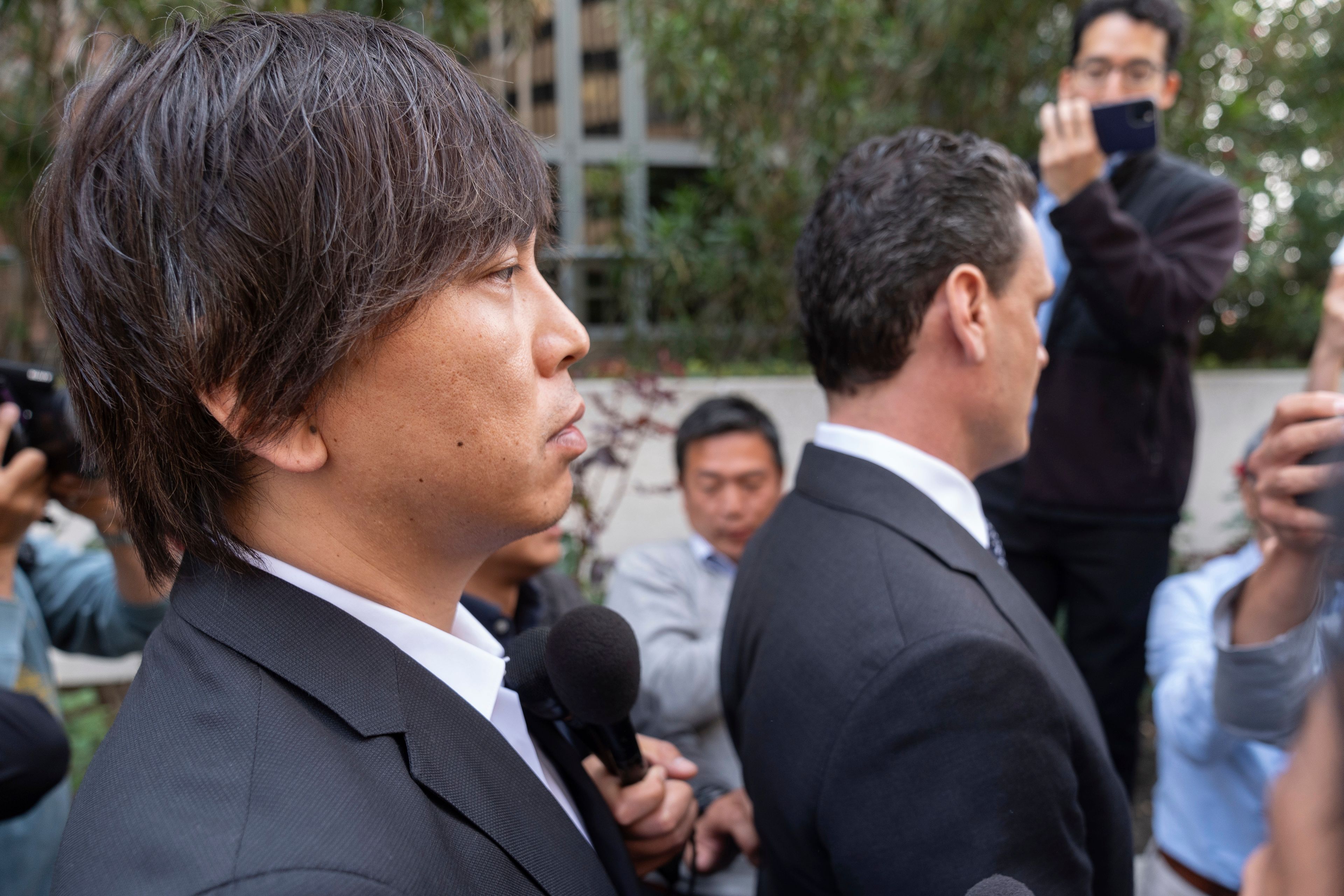 FILE - Ippei Mizuhara, left, the former longtime interpreter for the Los Angeles Dodgers baseball star Shohei Ohtani, and his defense attorney, Michael Freedman, right, leave federal court following his arraignment, Tuesday, May 14, 2024, in Los Angeles. Mizuhara is scheduled to plead guilty Tuesday, June 4, 2024, to bank and tax fraud in a sports betting case where he is expected to admit to stealing nearly $17 million from the Japanese baseball player.