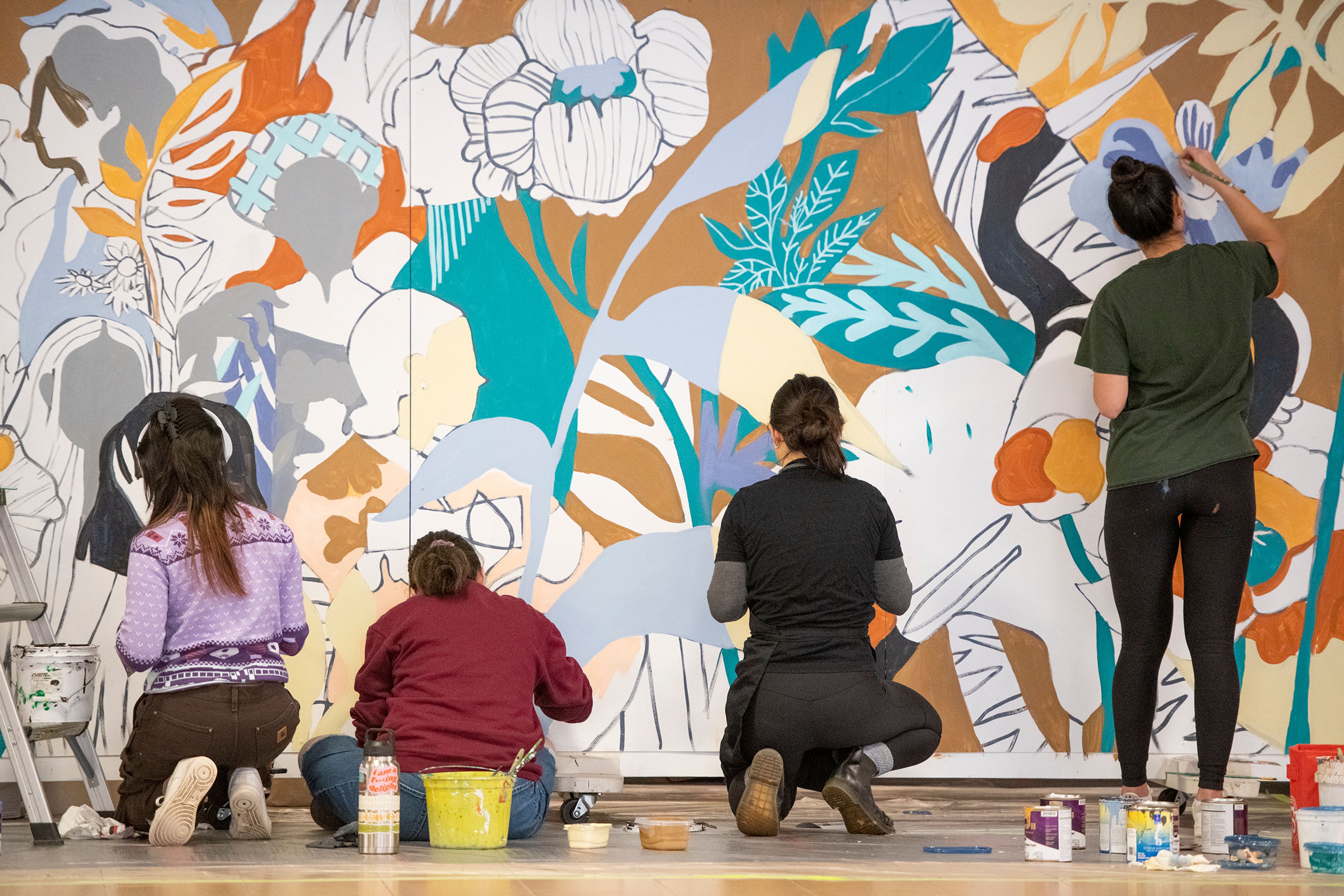 Artists Jiemei Lin, Reika Pratt, Kari Samio and Heidi Lee paint a mural Tuesday at Washington State University’s Compton Union Building in Pullman for the National Day of Racial Healing.