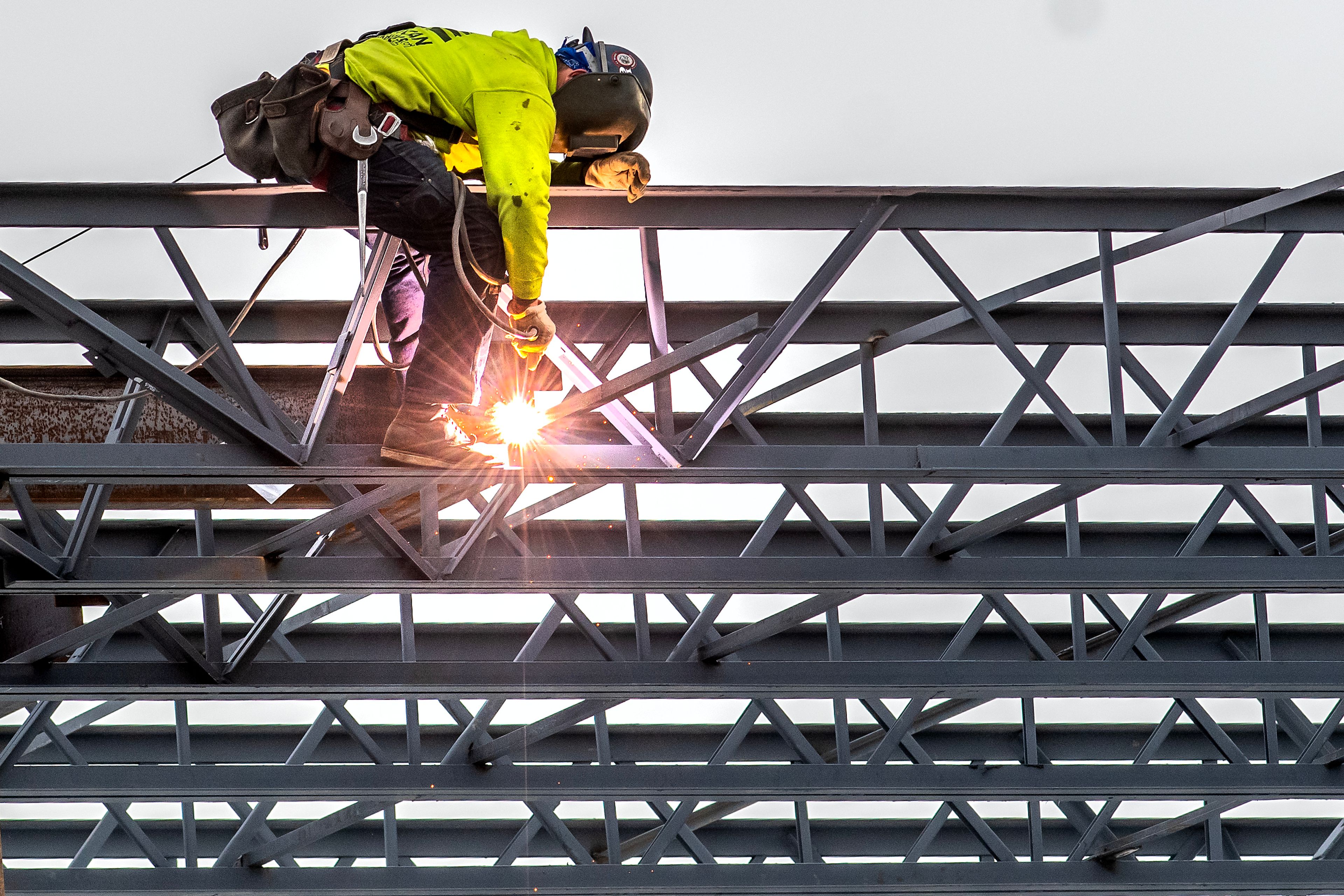 A worker cuts away the excess of a beam while working on construction of the new Nez Perce County Courthouse on Tuesday in Lewiston.