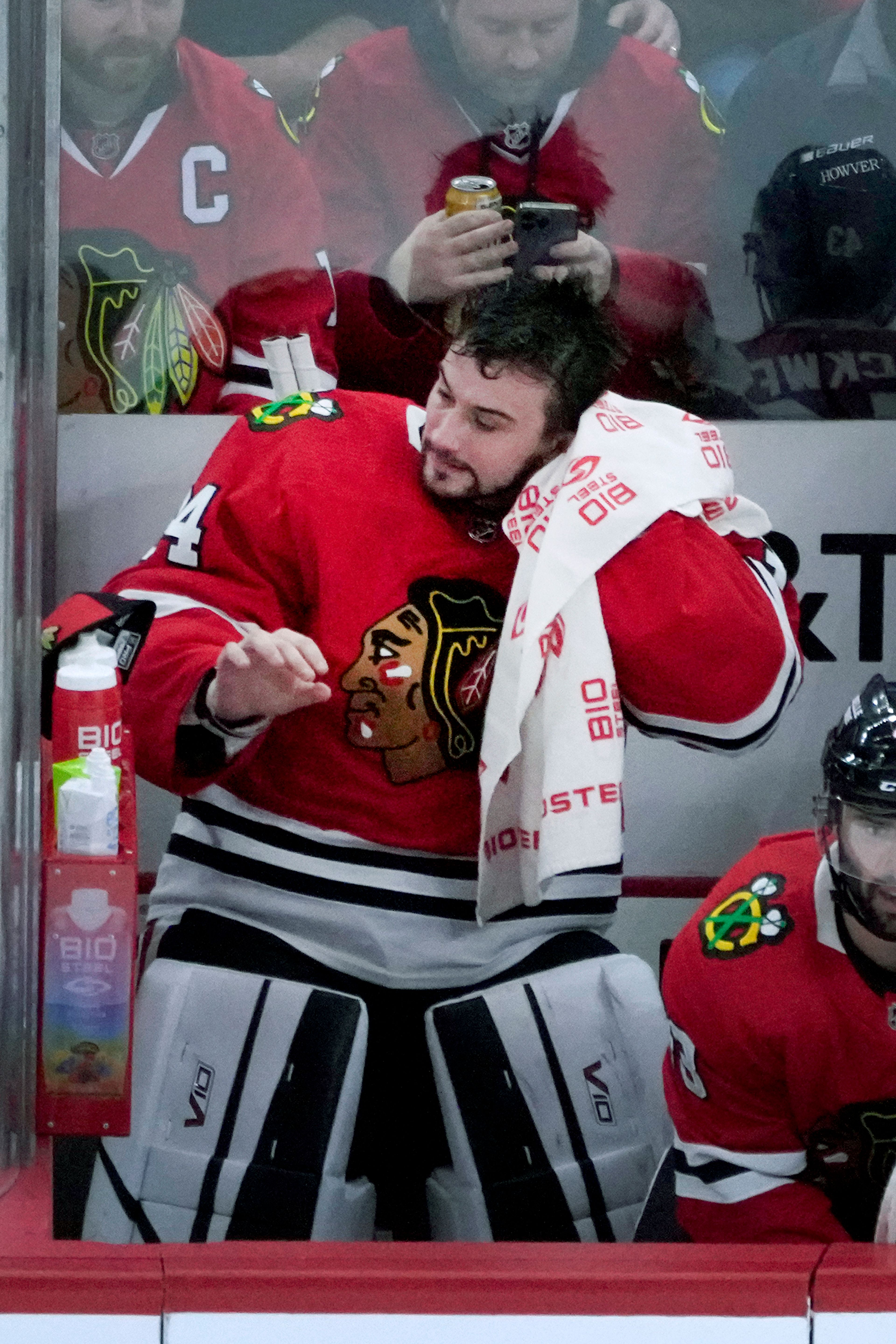 Chicago Blackhawks goaltender Petr Mrazek wipes his head after being replaced during the first period of the team's NHL hockey game against the Seattle Kraken on Saturday, Jan. 14, 2023, in Chicago. (AP Photo/Charles Rex Arbogast)