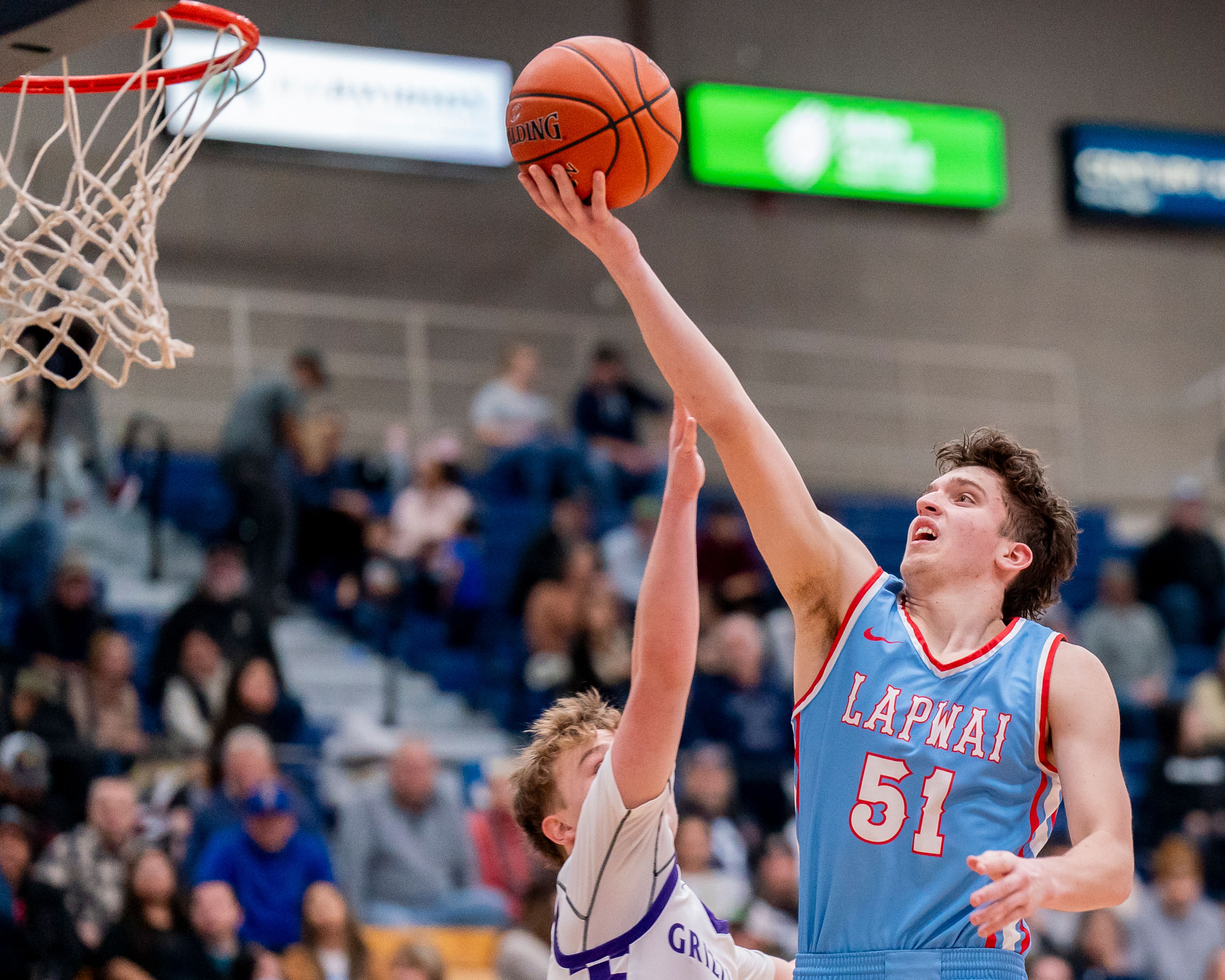 Lapwai’s Kase Wynott, right, attempts a layup during a game against Rocky Mountain in the Avista Holiday Tournament on Dec. 29 at the P1FCU Activity Center in Lewiston.