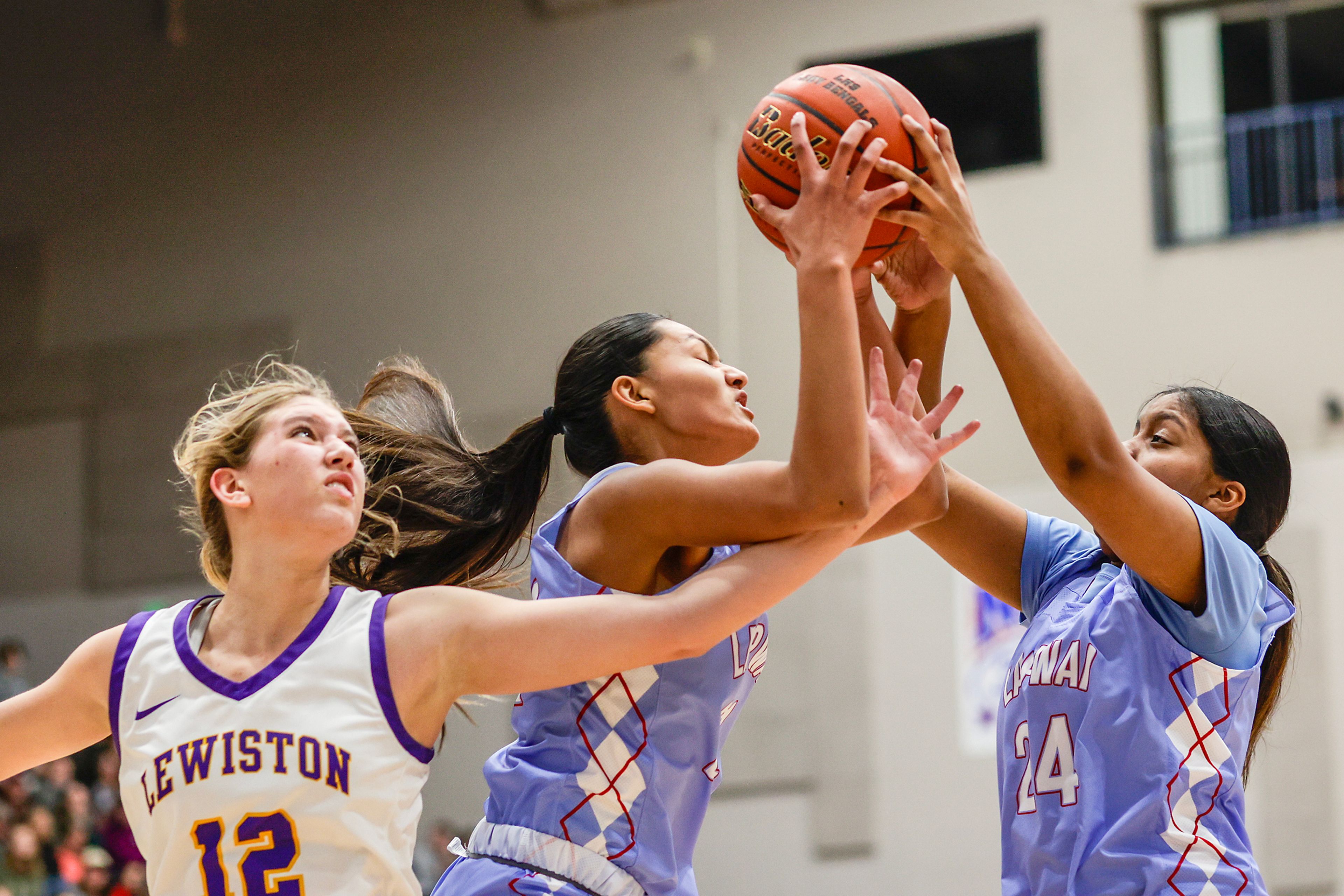 Lapwai center Jayden Leighton grabs the rebound away from Lewiston post Addison McKarcher during the Avista Holiday Tournament on Wednesday.