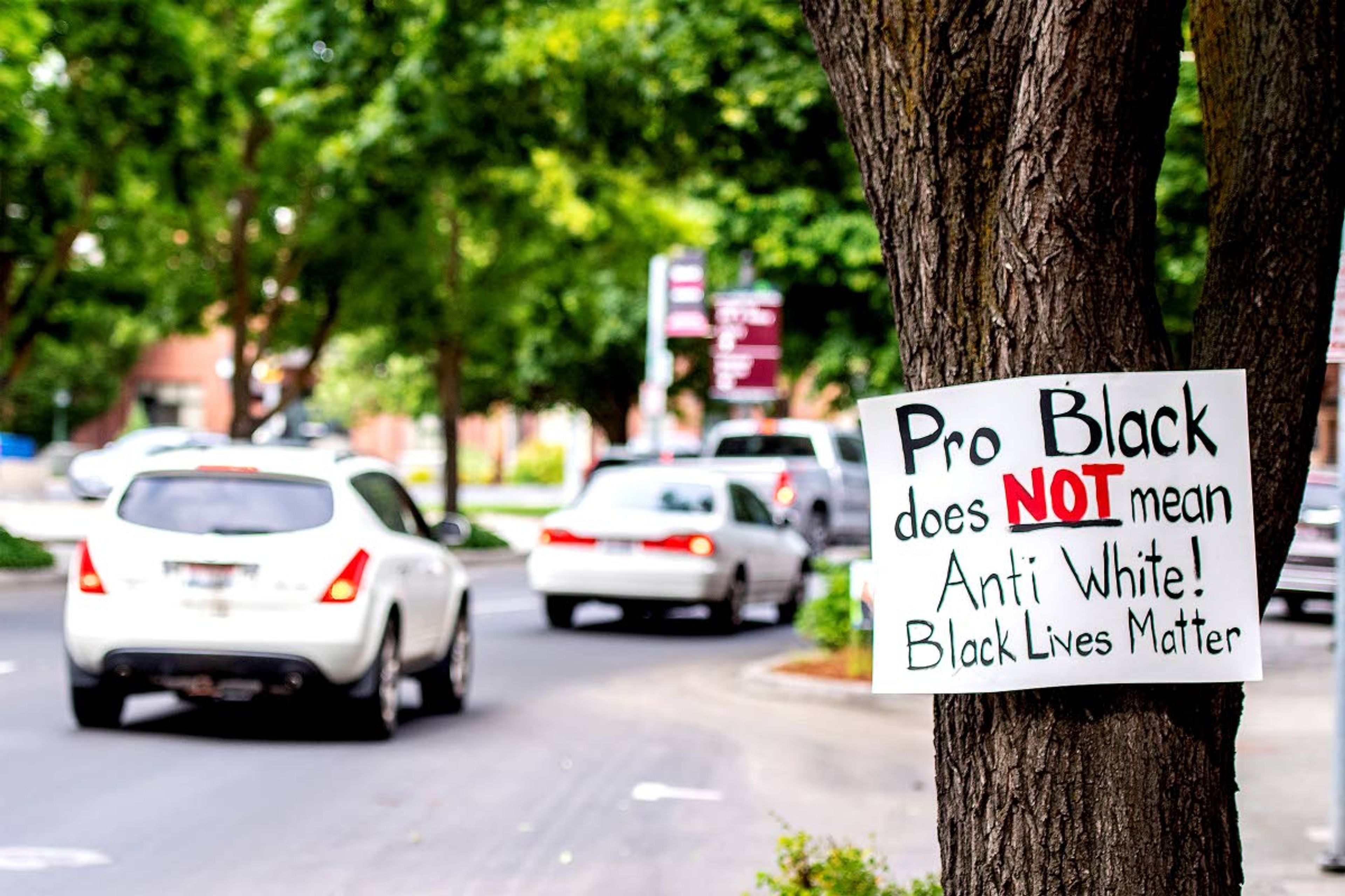 A sign hangs on a tree on Main Street in downtown Lewiston on Friday evening. The Black Lives Matter Peace Rally is scheduled to take place at Kiwanis Park at 11 a.m. today. At the same time, the Defend Lewiston 2nd Amendment Rally will be held at Brackenbury Square.