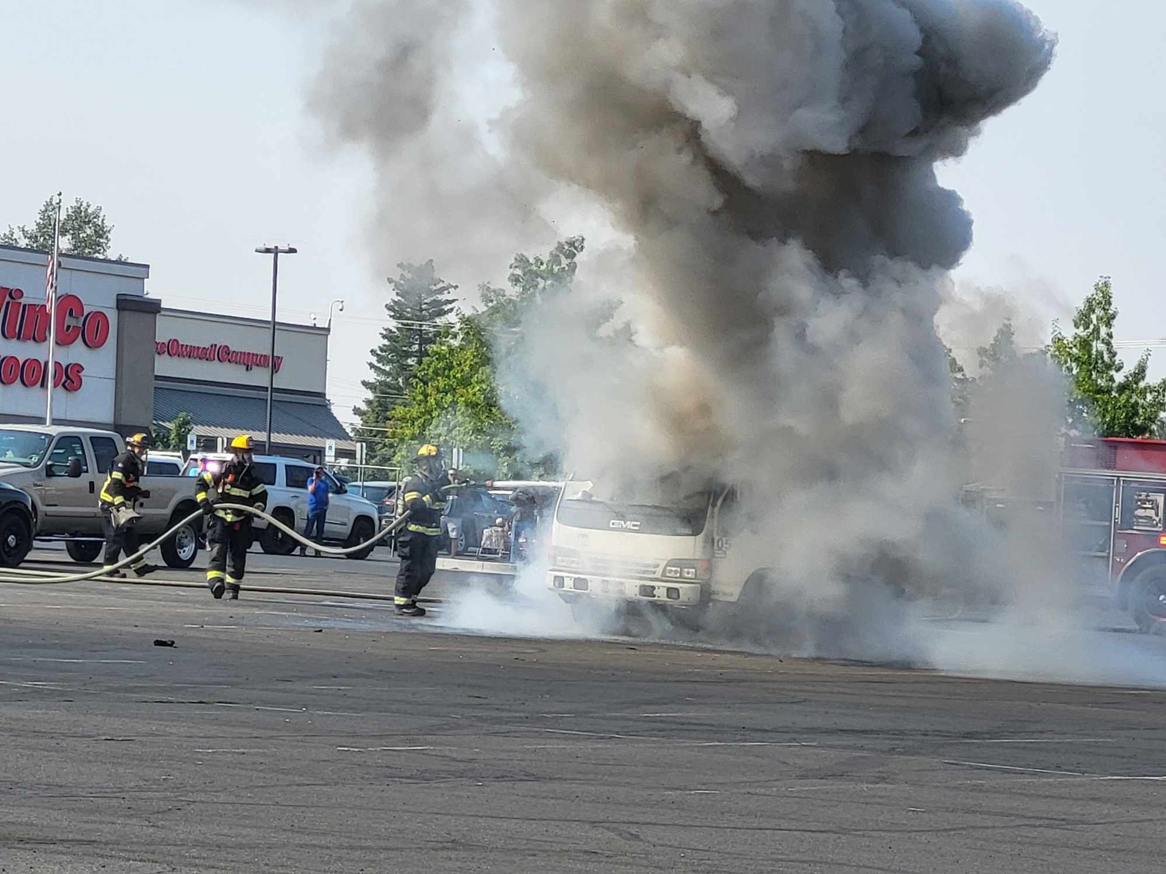 Firefighters work to put out a vehicle fire at the Lewiston Center Mall on Saturday morning.