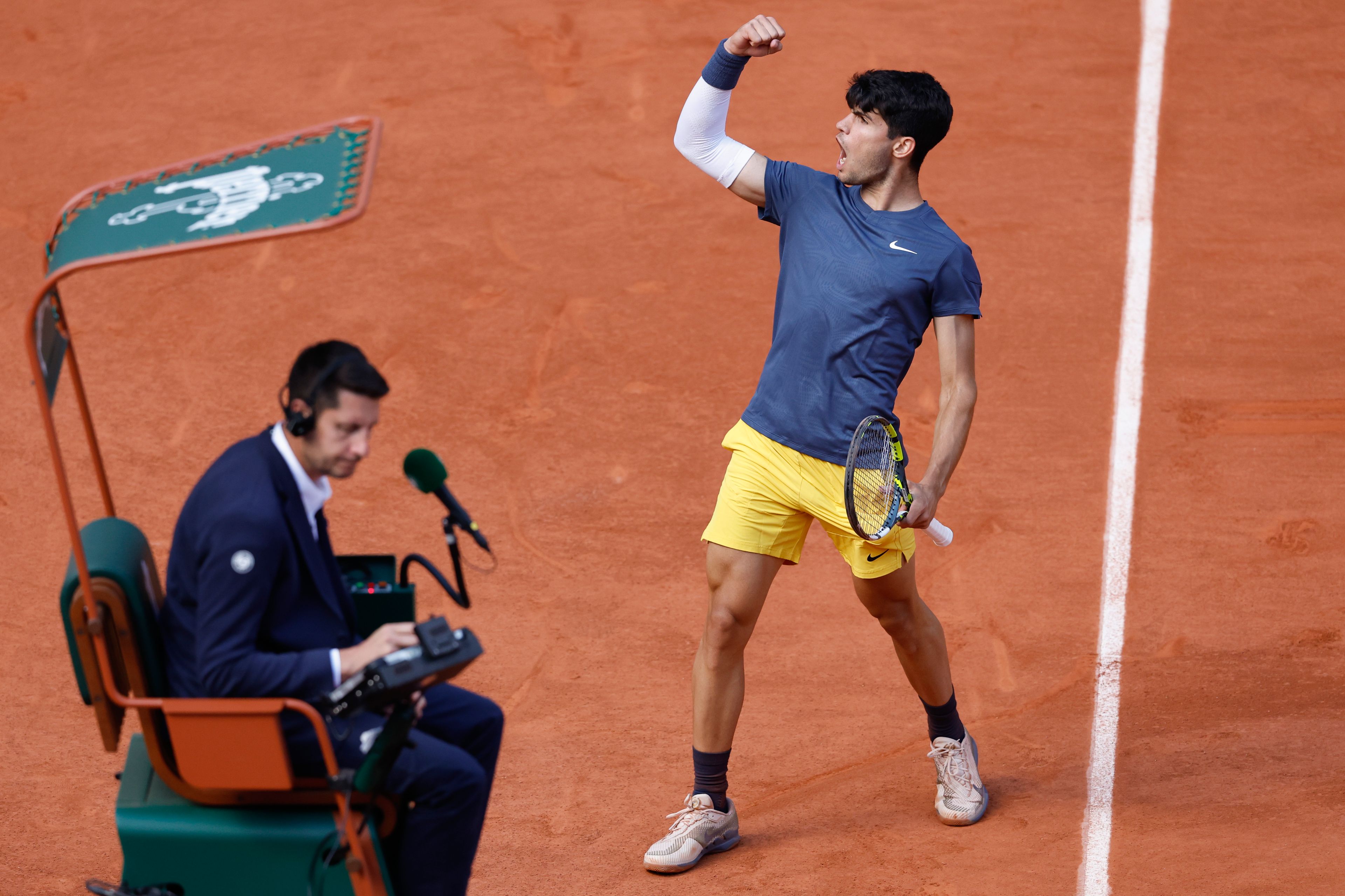 Spain's Carlos Alcaraz celebrates next to chair umpire Renaud Lichtenstein after scoring against Germany's Alexander Zverev during the men's final of the French Open tennis tournament at the Roland Garros stadium in Paris, France, Sunday, June 9, 2024.