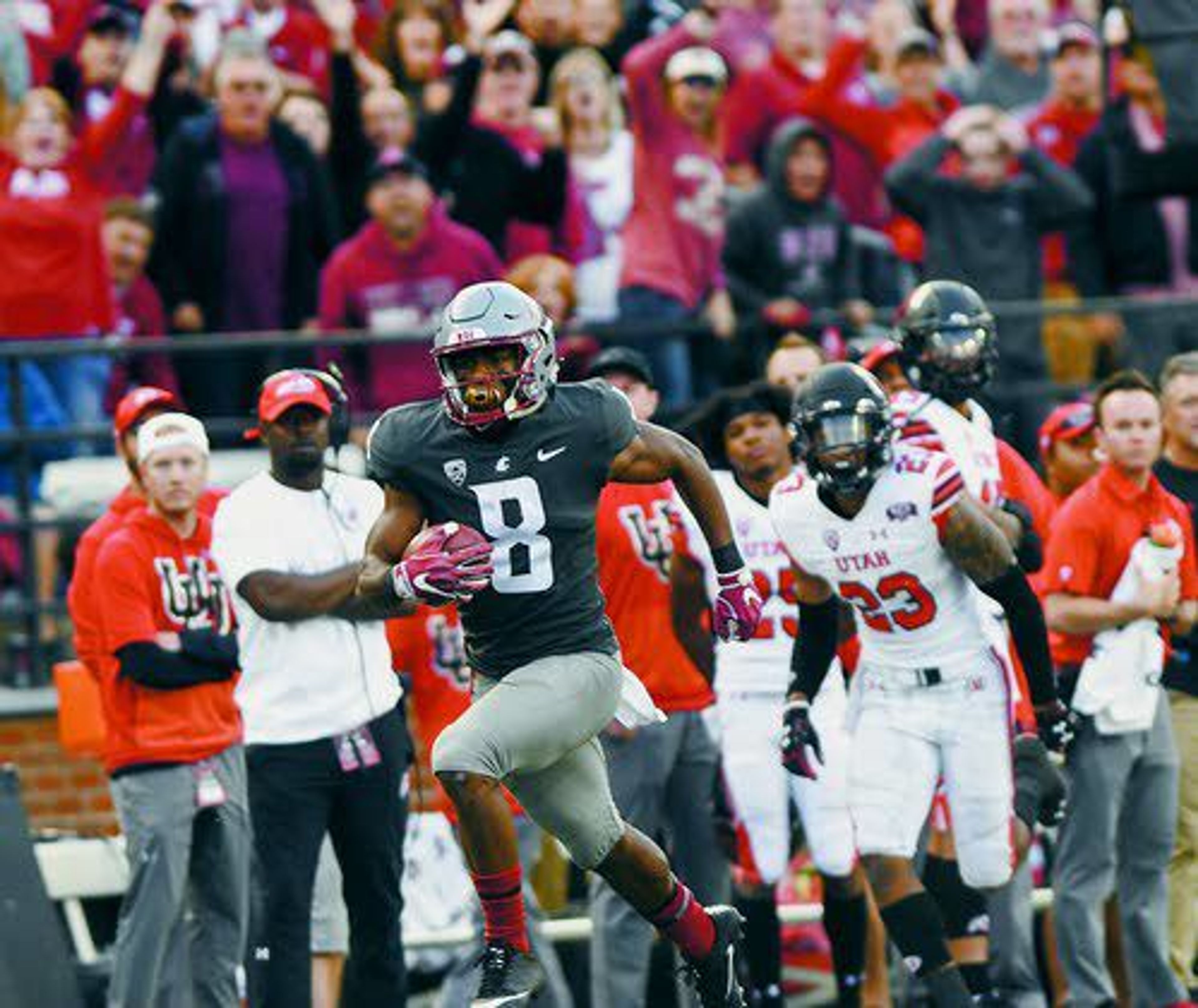 After catching a pass from quarterback Gardner Minshew (16), Washington State wide receiver Easop Winston (8) races toward the end zone past Utah defensive back Julian Blackmon (23) as fans cheer him on during the fourth quarter of a PAC-12 Conference game on Saturday, Sept. 29, at Martin Stadium in Pullman.