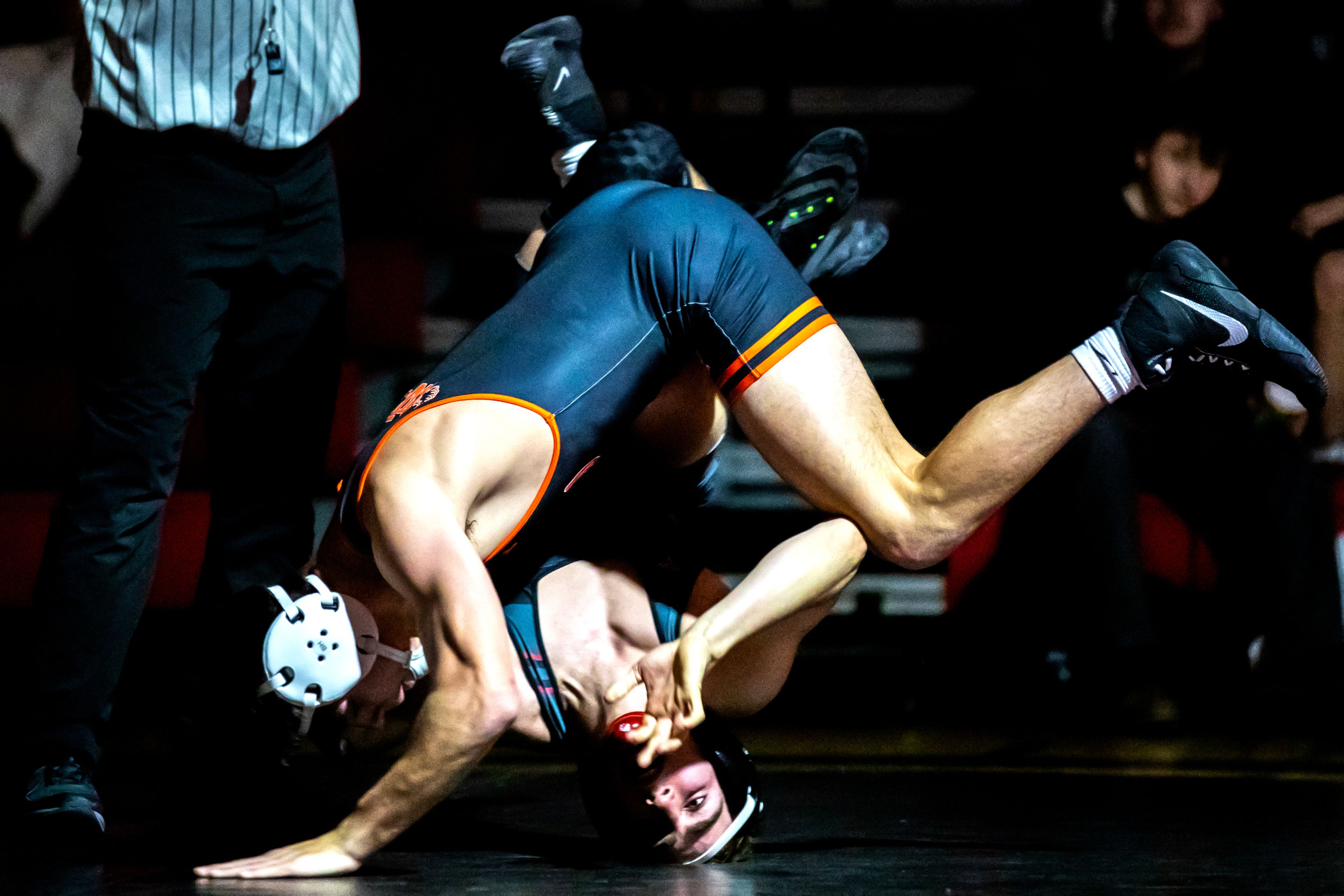 Clarkston’s Dawson Bailey and West Valley’s Logan Utecht flip out of the ring in the 144 pound weight class match during a wrestling duel Wednesday at Clarkston.