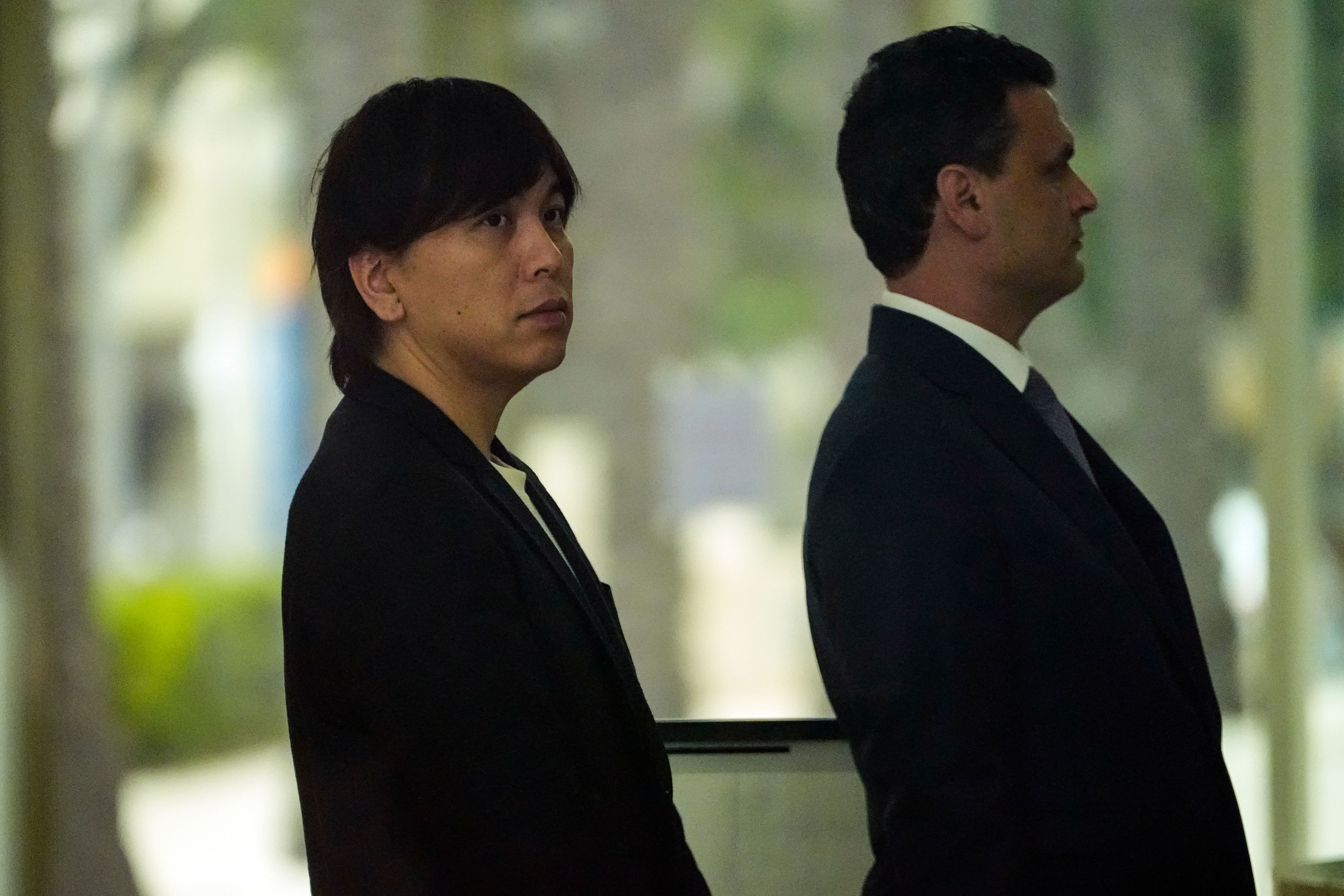 Ippei Mizuhara, left, the former interpreter for the Los Angeles Dodgers baseball star Shohei Ohtani, arrives at federal court with his defense attorney, Michael Freedman, in Los Angeles, Tuesday, June 4, 2024. Mizuhara pleaded guilty to bank and tax fraud on Tuesday and admitted to stealing nearly $17 million from the Japanese baseball player to pay off sports betting debts.