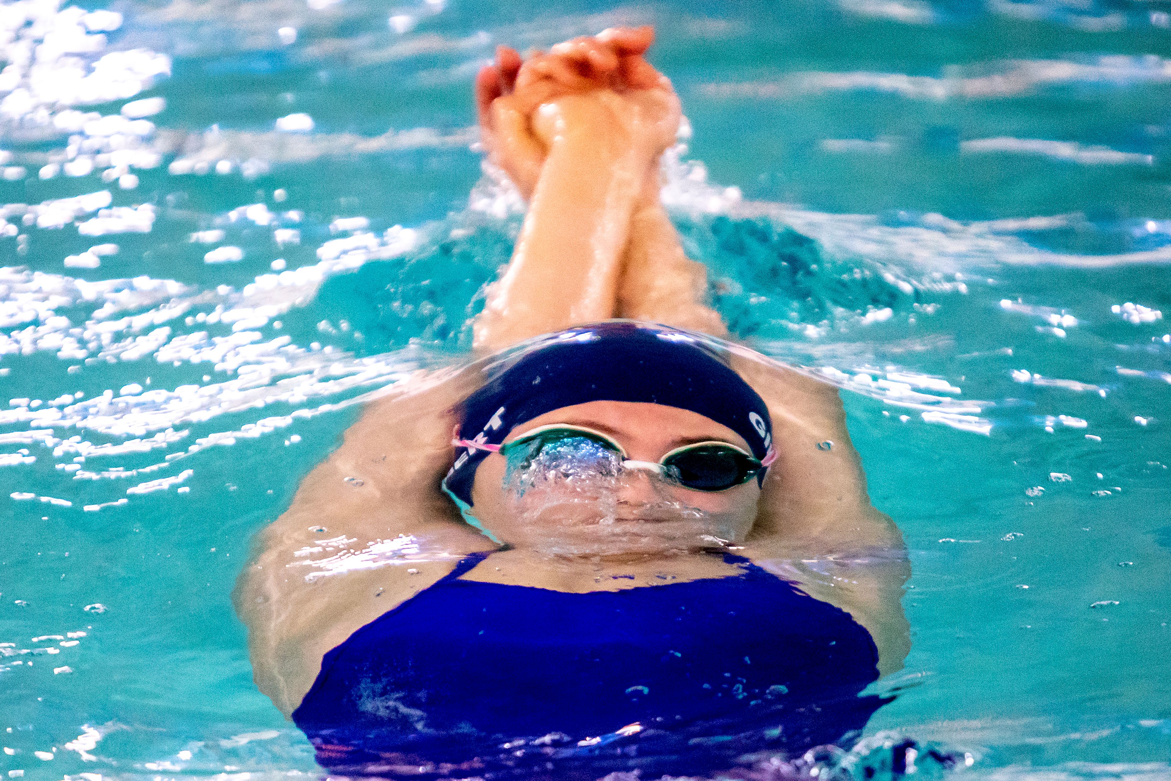 A swimmer prepares to break the surface of the water after kicking back off the wall during practice at the Pullman Aquatic Center on Wednesday.