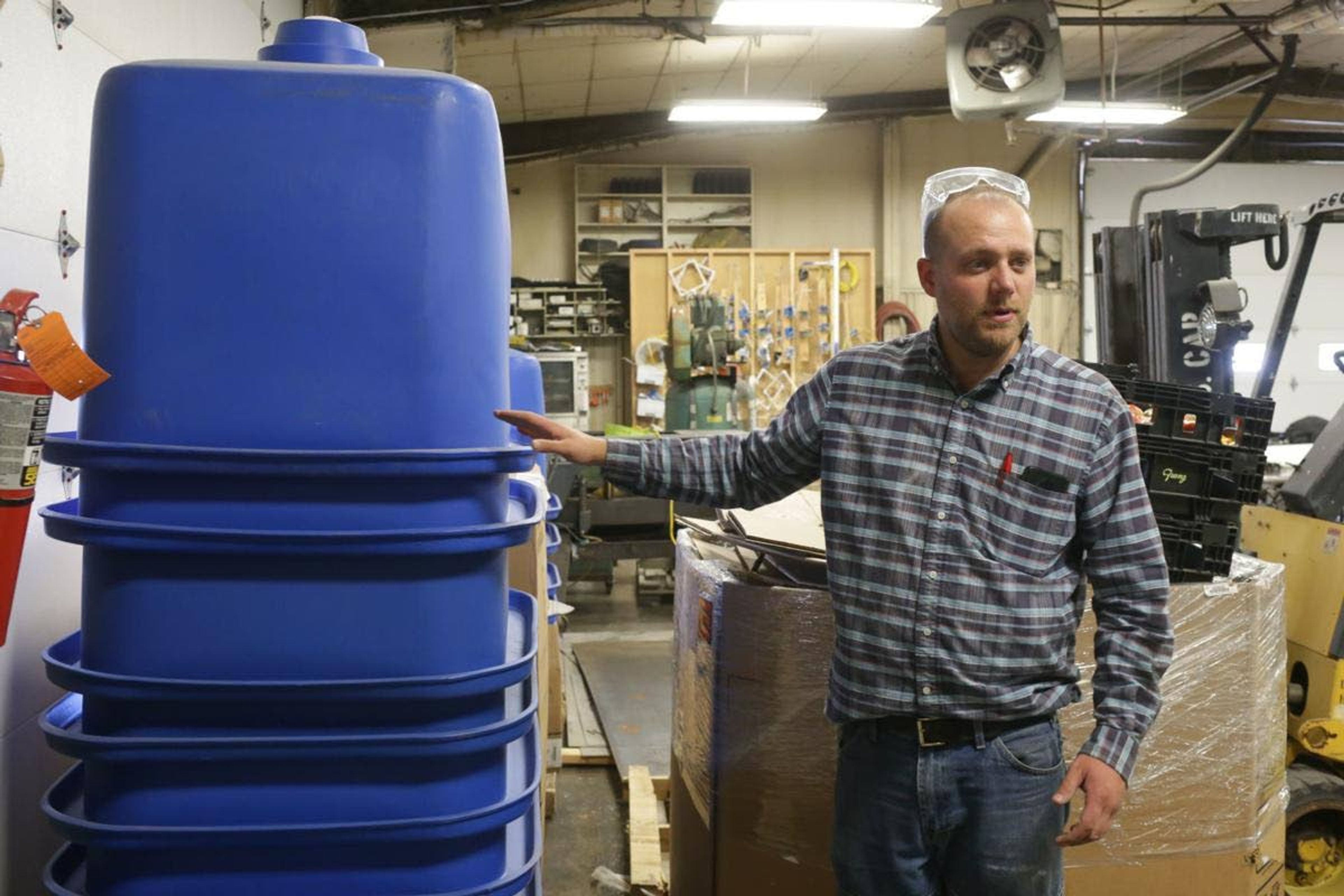 Trent Van Leuven, aquaculture teacher at Mackay High School, displays fish holding tanks.