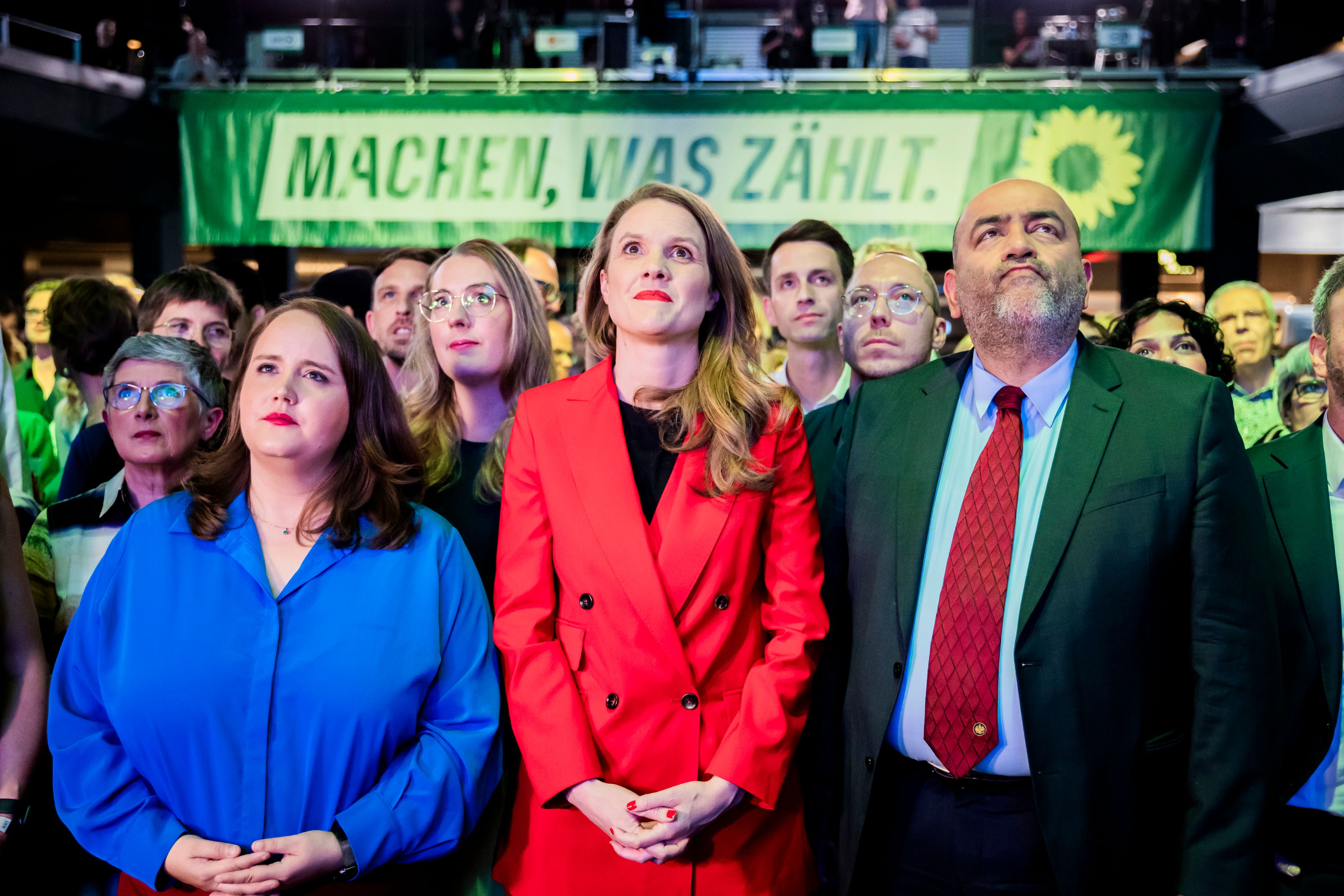 From left, Ricarda Lang, Federal Chairperson of Bündnis 90/Die Grünen, Terry Reintke, the Greens' lead candidate for the 2024 European elections, and Omid Nouripour, Federal Chairperson of Bündnis 90/Die Grünen, react to the first projections at the Greens' election party in the Columbiahalle, in Berlin, Sunday June 9, 2024.