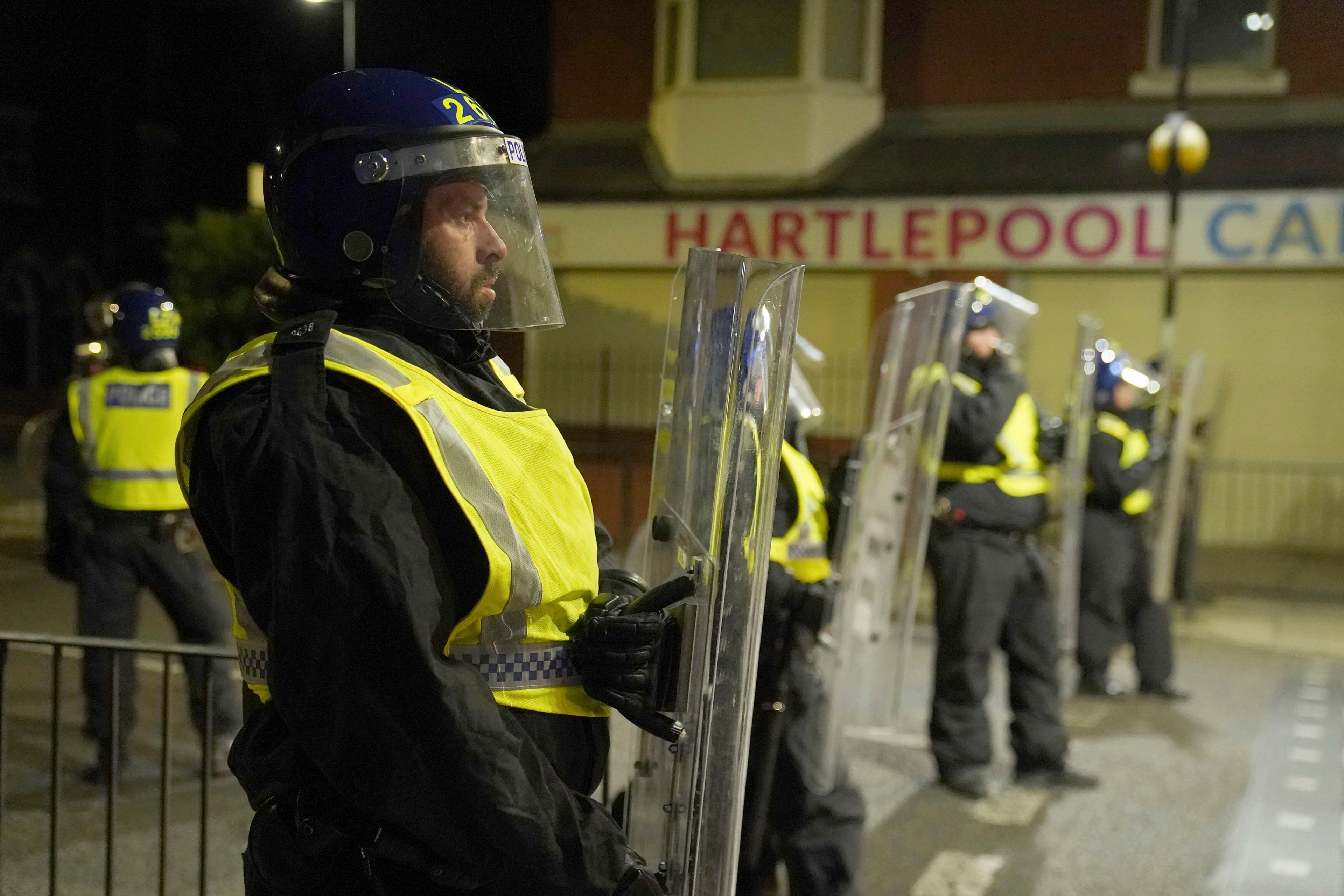 Police officers stand guard on the streets of Hartlepool, England, following a violent protest in the wake of the killing of three girls who were fatally stabbed in northwest England, Wednesday, July 31, 2024. Far-right groups seek to stir anger over an attack they have sought to link â€” without evidence â€” to immigrants. (Owen Humphreys/PA via AP)