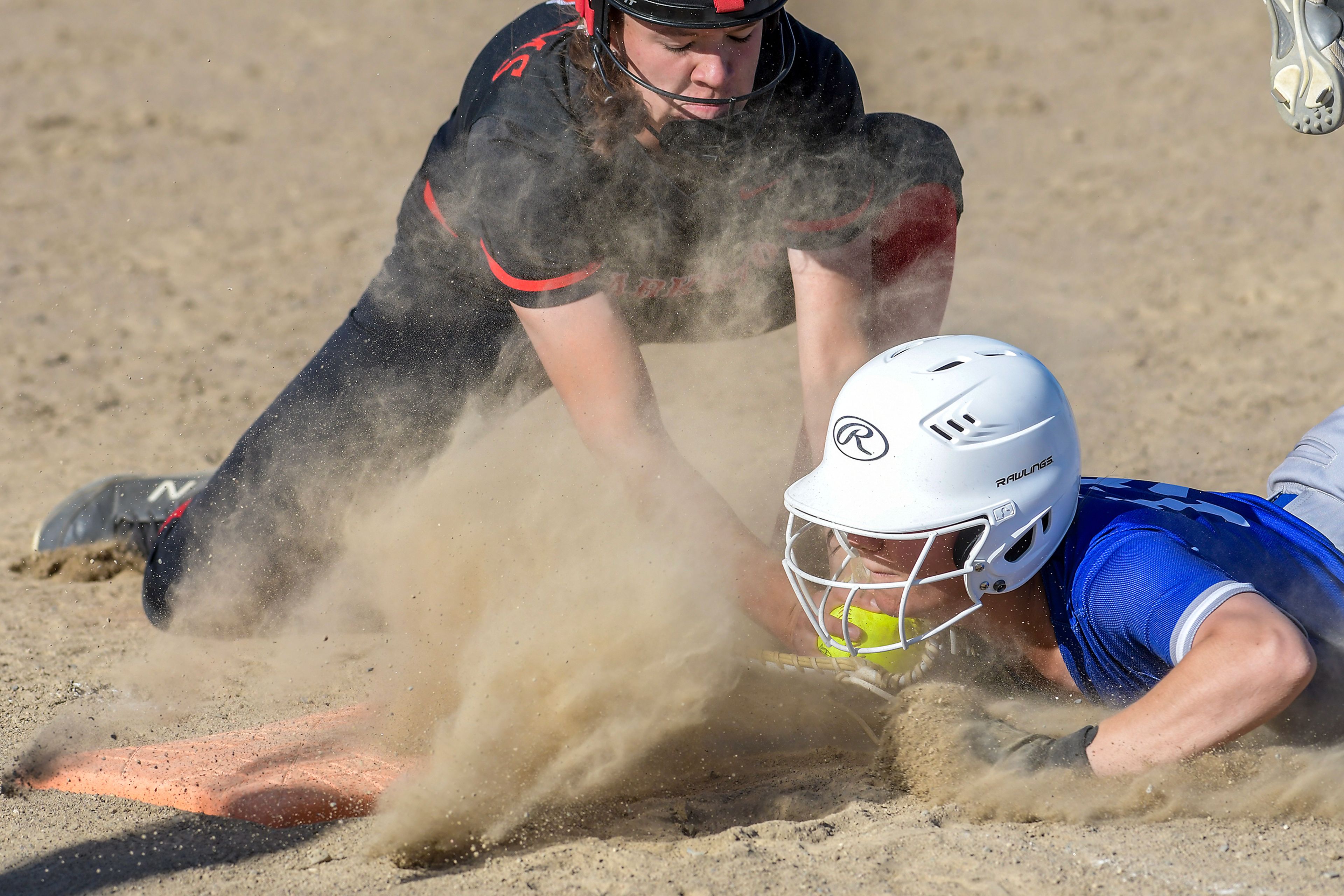 Clarkston first baseman Murray Broemeling attempts to tag out Pullman’s Sammi Turner as she dives back to second in an inning of a district tournament semifinal round game Thursday in Clarkston.