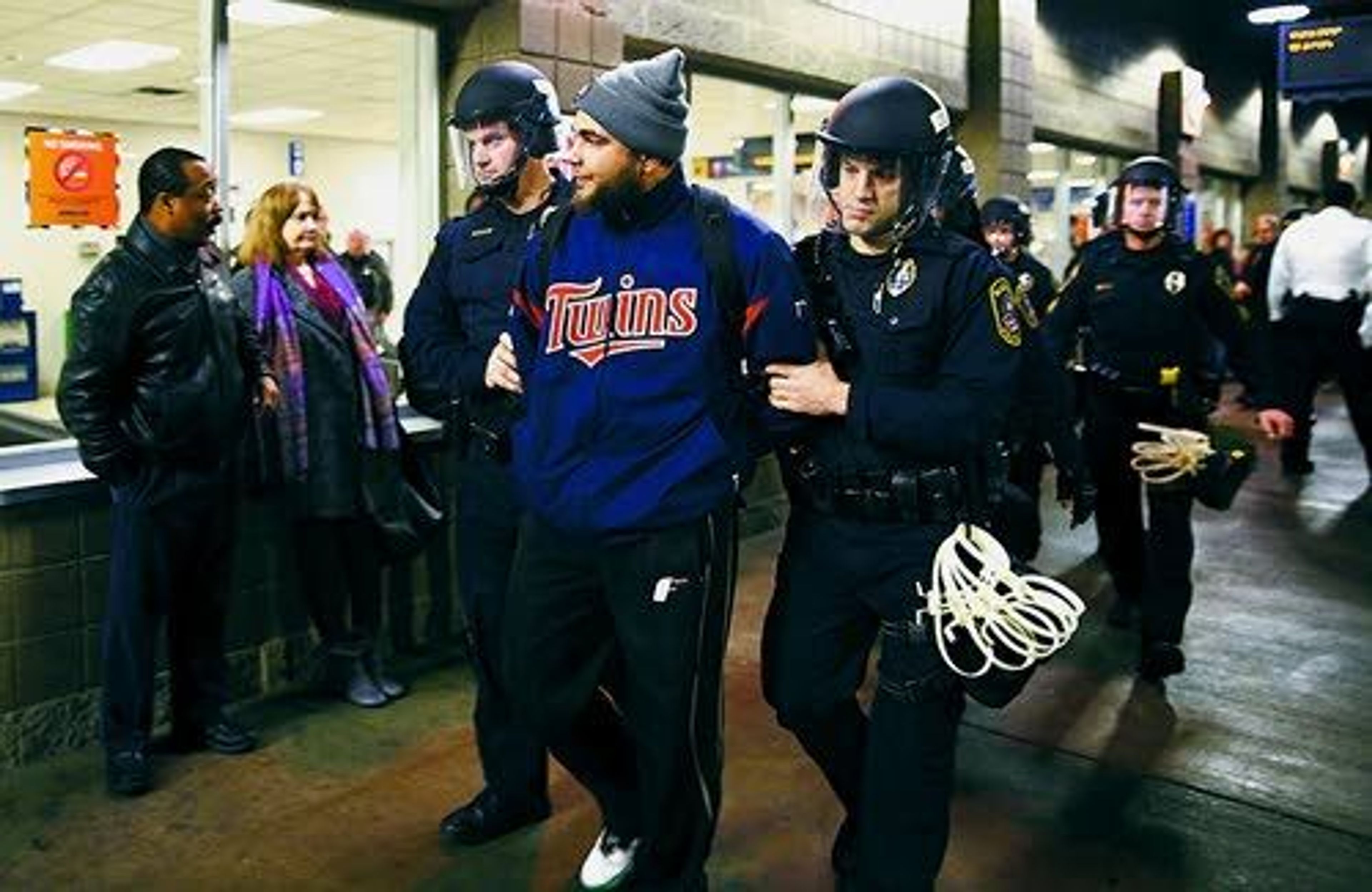 Leila Navidi/Star Tribune via APPolice detain a protester Wednesday at the Mall of America. A large protest that started at the Mall of America quickly migrated to Minneapolis-St. Paul International Airport, where demonstrators blocked roads and caused significant traffic delays.