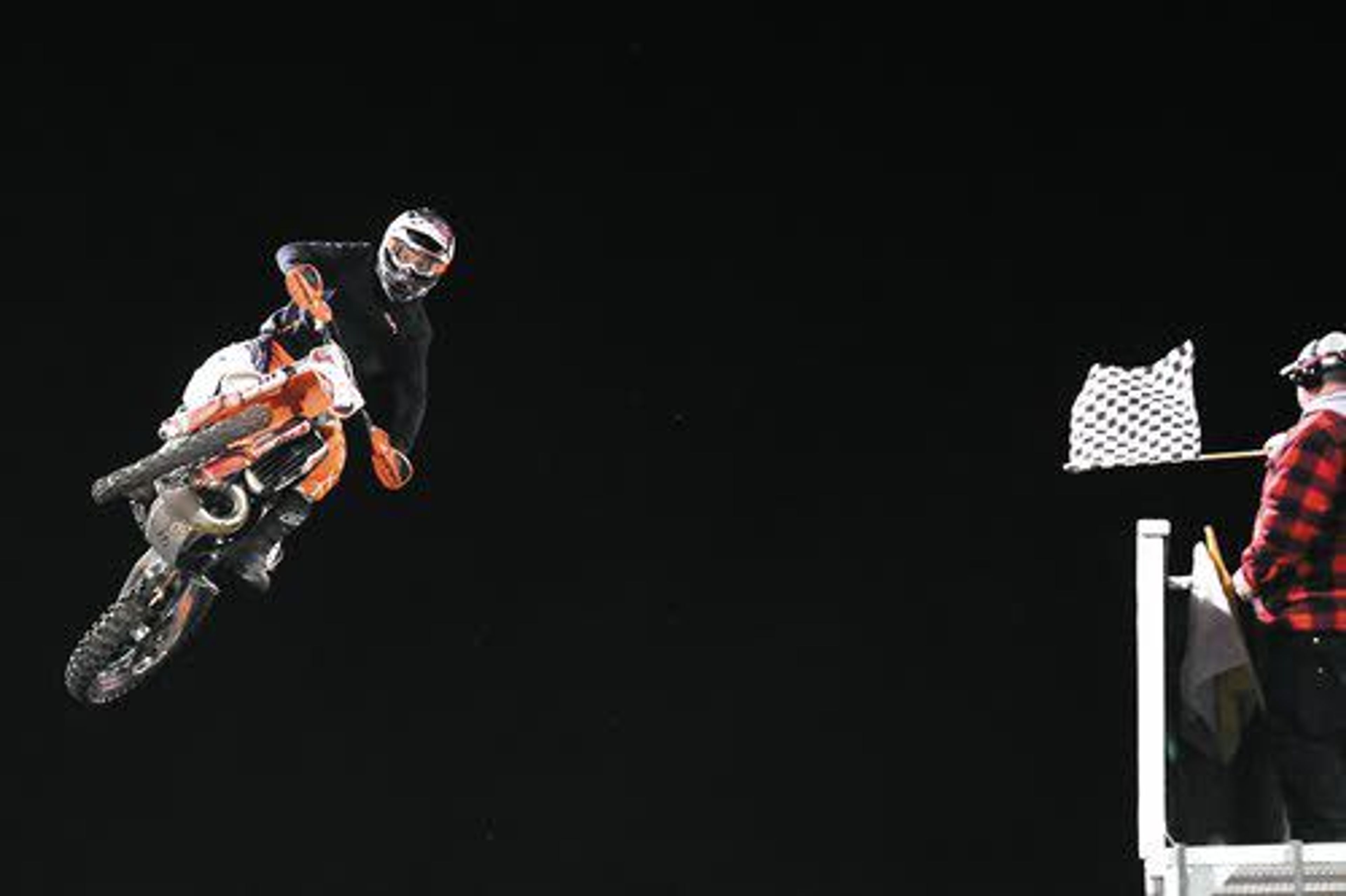 Garrett Flach, of St. Maries, takes the checkered flag in the 125cc intermediate race on Saturday night at the Lewiston Supercross event at the Lewiston Roundup Grounds.