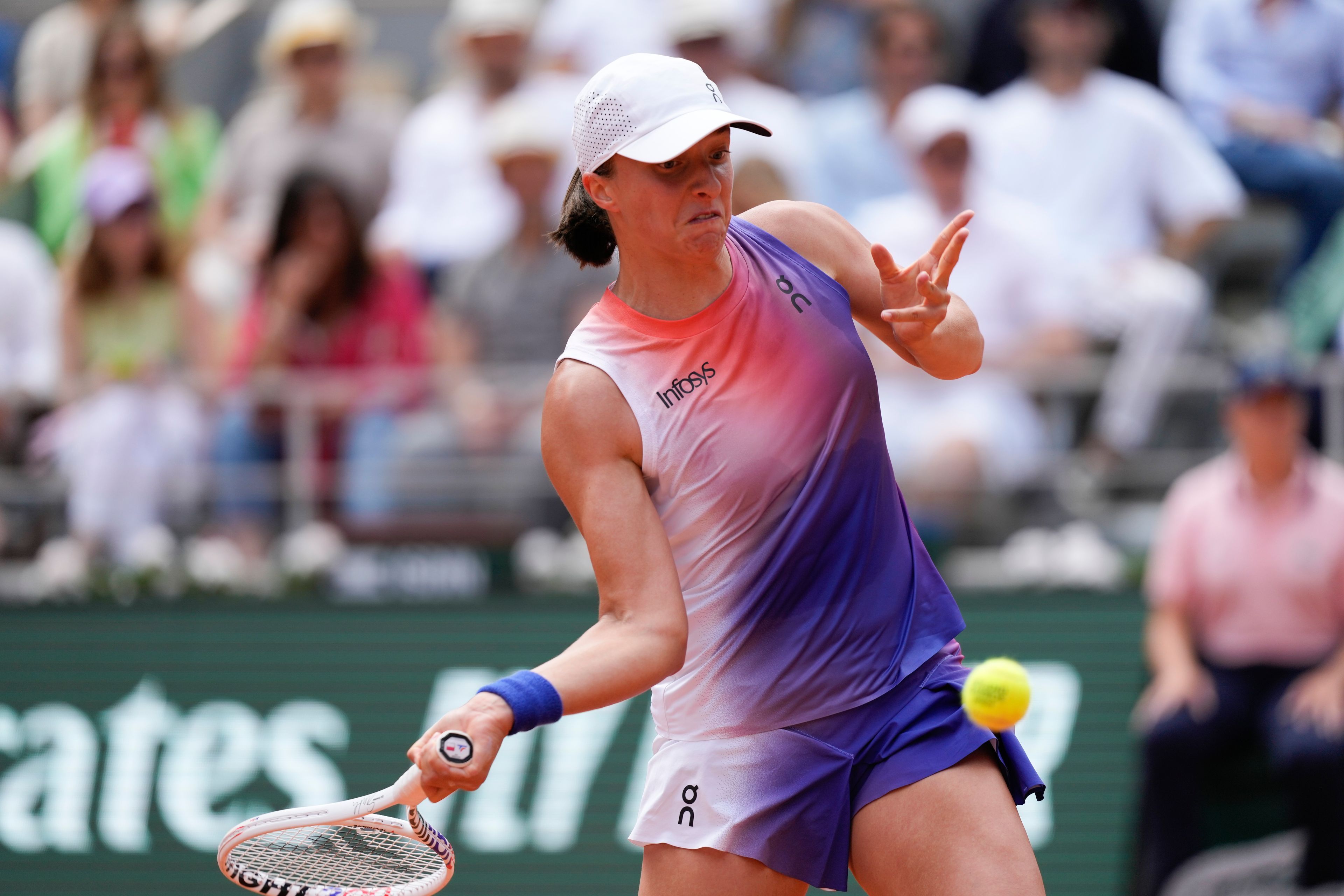 Poland's Iga Swiatek plays a shot against Italy's Jasmine Paolini during the women's final of the French Open tennis tournament at the Roland Garros stadium in Paris, France, Saturday, June 8, 2024.