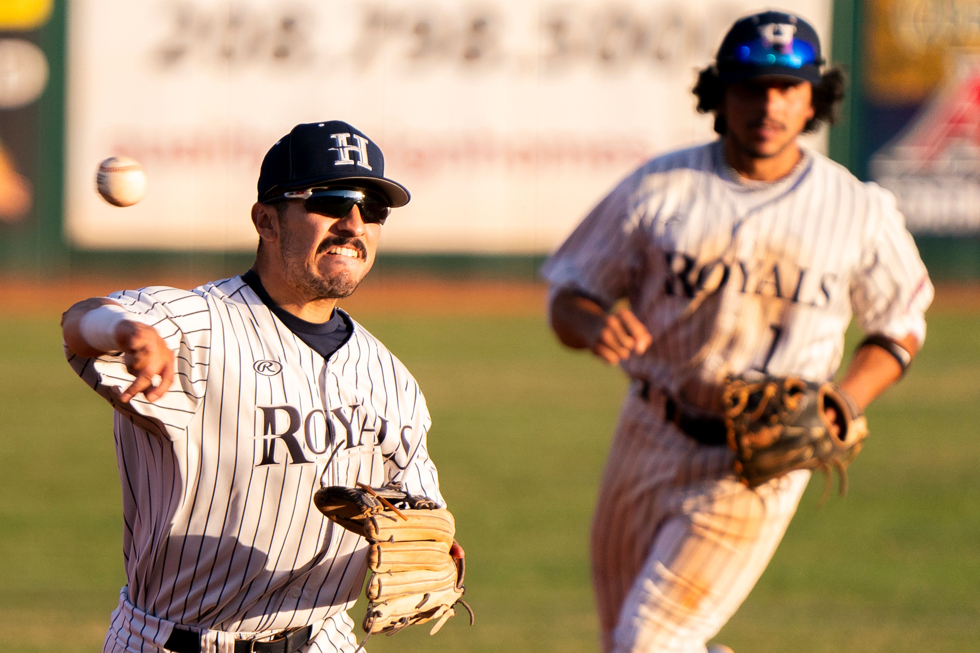 Hope International third baseman Alex Moreno, left, throws the ball to first base during Game 19 of the NAIA World Series against Tennessee Wesleyan on Friday at Harris Field in Lewiston.