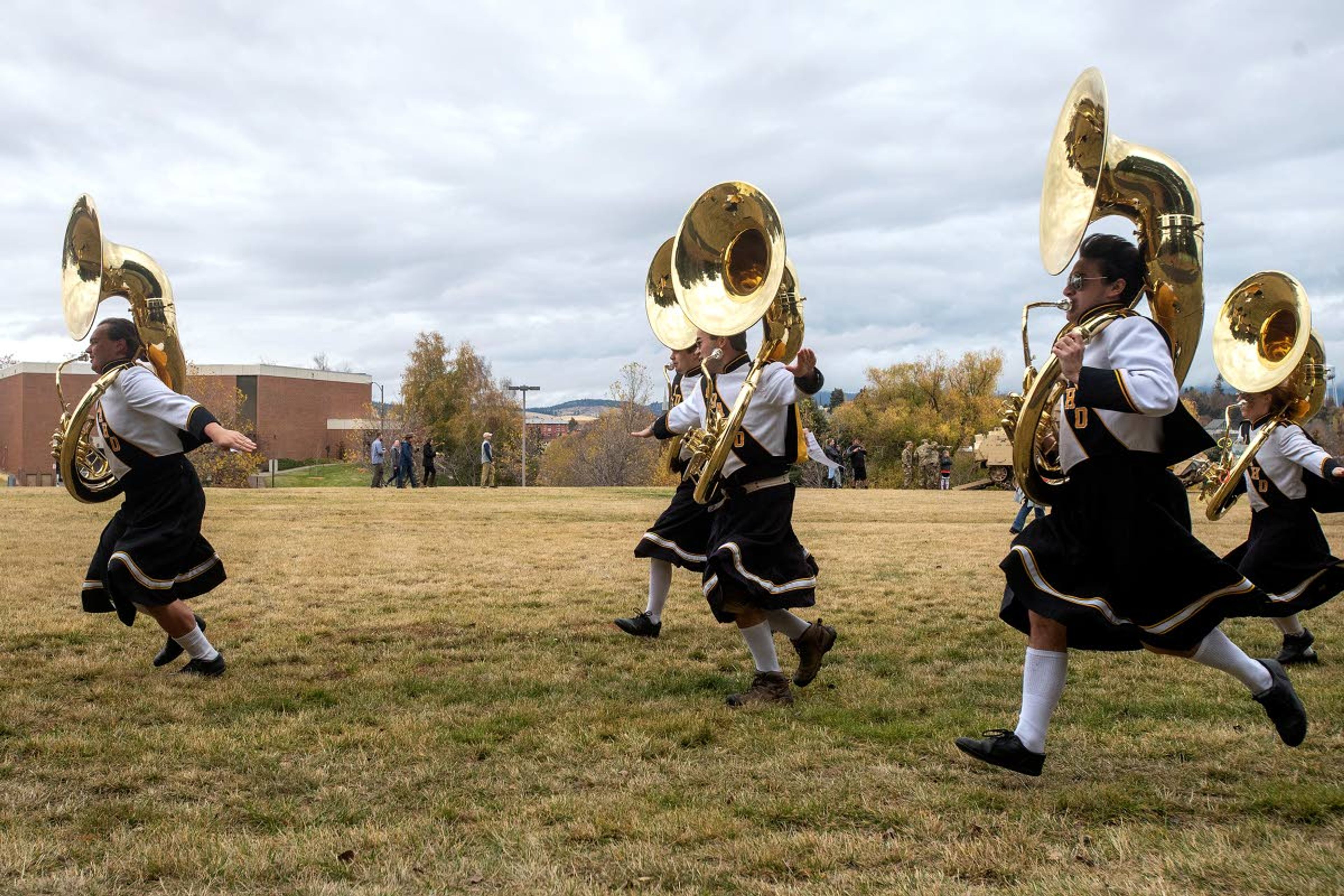 RIGHT: With their arms held out from their sides, the marauding Vandal sousaphone players begin to make their rounds of University of Idaho tailgate parties prior to kickoff of the Nov. 3 football game against North Dakota. The group of eight perform with gusto to anyone willing to listen to the sweet sounds of the sousaphone blasting the Vandal fight song or their rendition of “In Heaven There Is No Beer.”