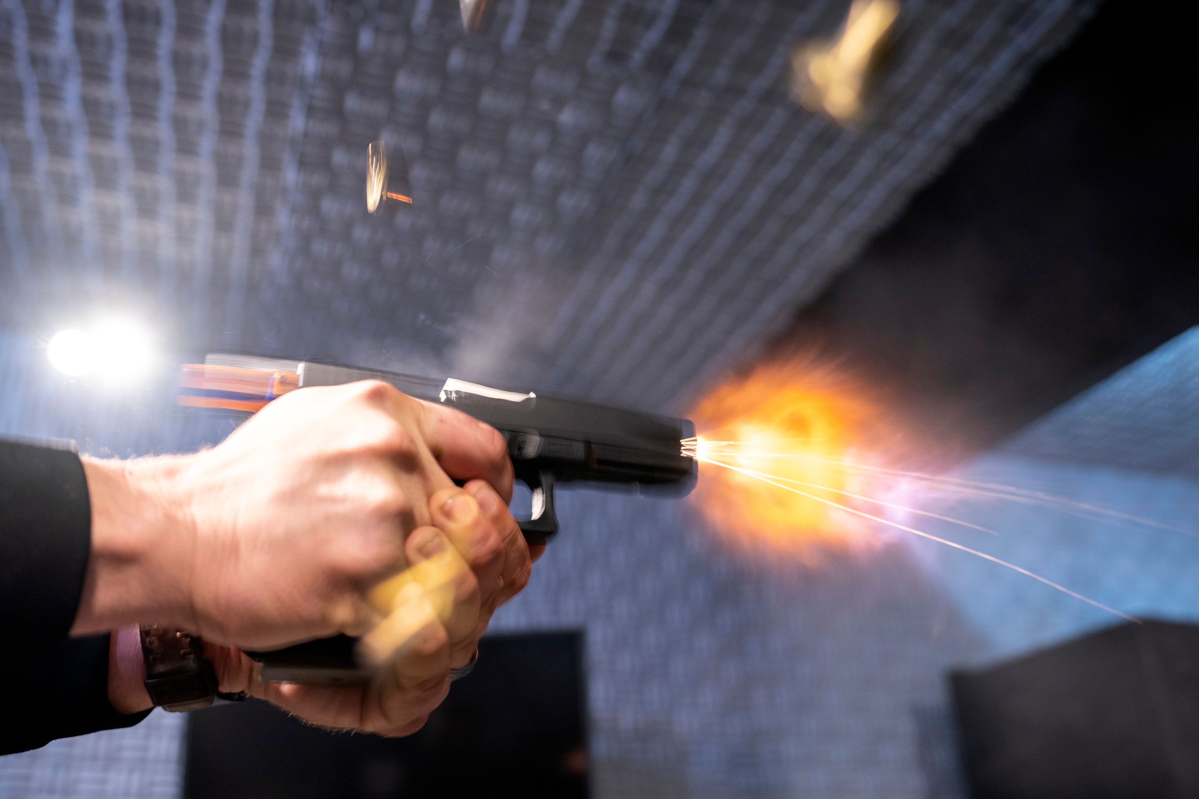 FILE - A semi-automatic pistol with a conversion device installed making it fully automatic is fired as four empty shell casings fly out of the weapon, at the Bureau of Alcohol, Tobacco, Firearms, and Explosives (ATF), National Services Center, Thursday, March 2, 2023, in Martinsburg, W.Va. (AP Photo/Alex Brandon, File)