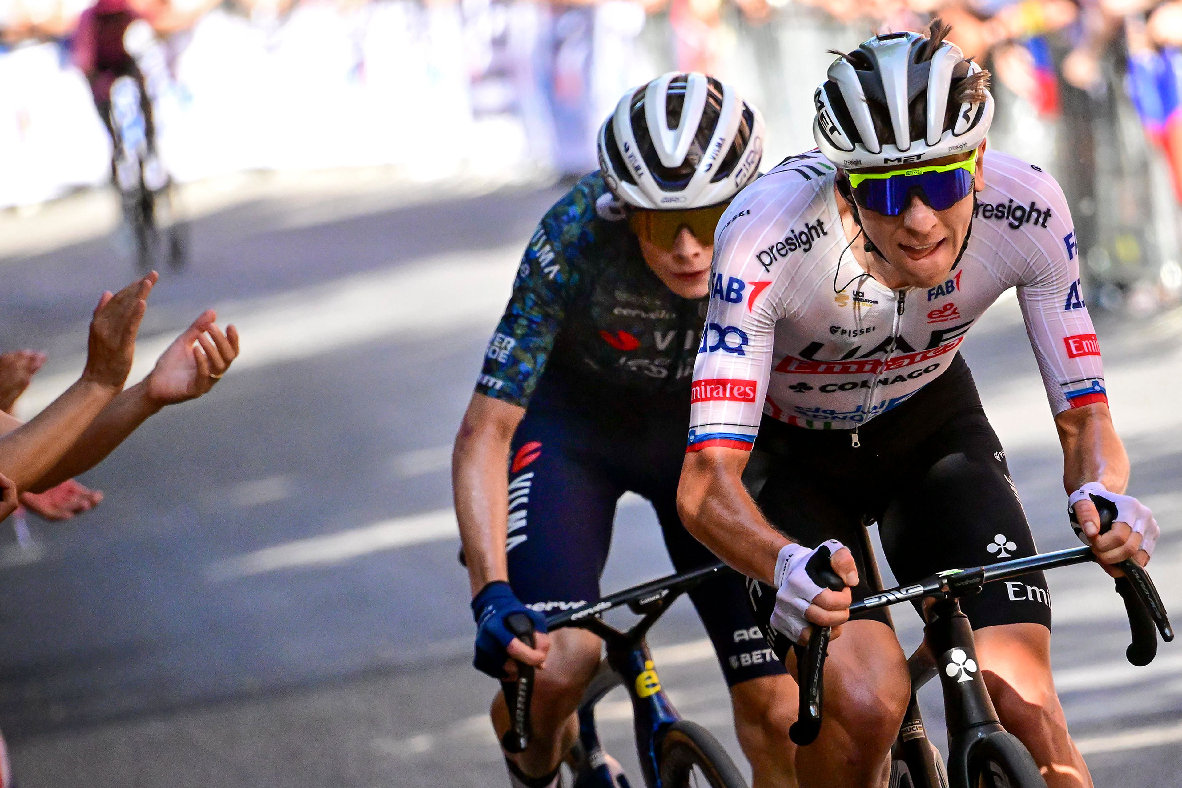 UAE Team Emirates’ Tadej Pogacar, front, of Slovenia, and Team Visma–Lease a Bike’s Jonas Vingegaard, of Denmark, break away from the pack during the second stage of the Tour de France over 199.2 kilometers with start in Cesenatico and finish in Bologna, Italy, Sunday, June 30, 2024. Pogacar and Vingegaard are the race favorites with Vingegaard winning the race in 2023, 2022, and placing second to Pogacar in 2021. Pogacar is coming off a victory in the Giro d'Italia and won the Tour in 2020 and 2021, and placed second to Vingegaard in 2022 and 2024. Only seven riders, Fausto Coppi, Jacques Anquetil, Eddy Merckx, Bernard Hinault, Stephen Roche, Miguel Induráin, and Marco Pantani, have won the Giro and Tour in one season, and only two riders, Merckx and Roche, have completed the triple crown of cycling; winning the Tour, Giro, and world championships in a single season. (Bernard Papon/Pool Photo via AP)