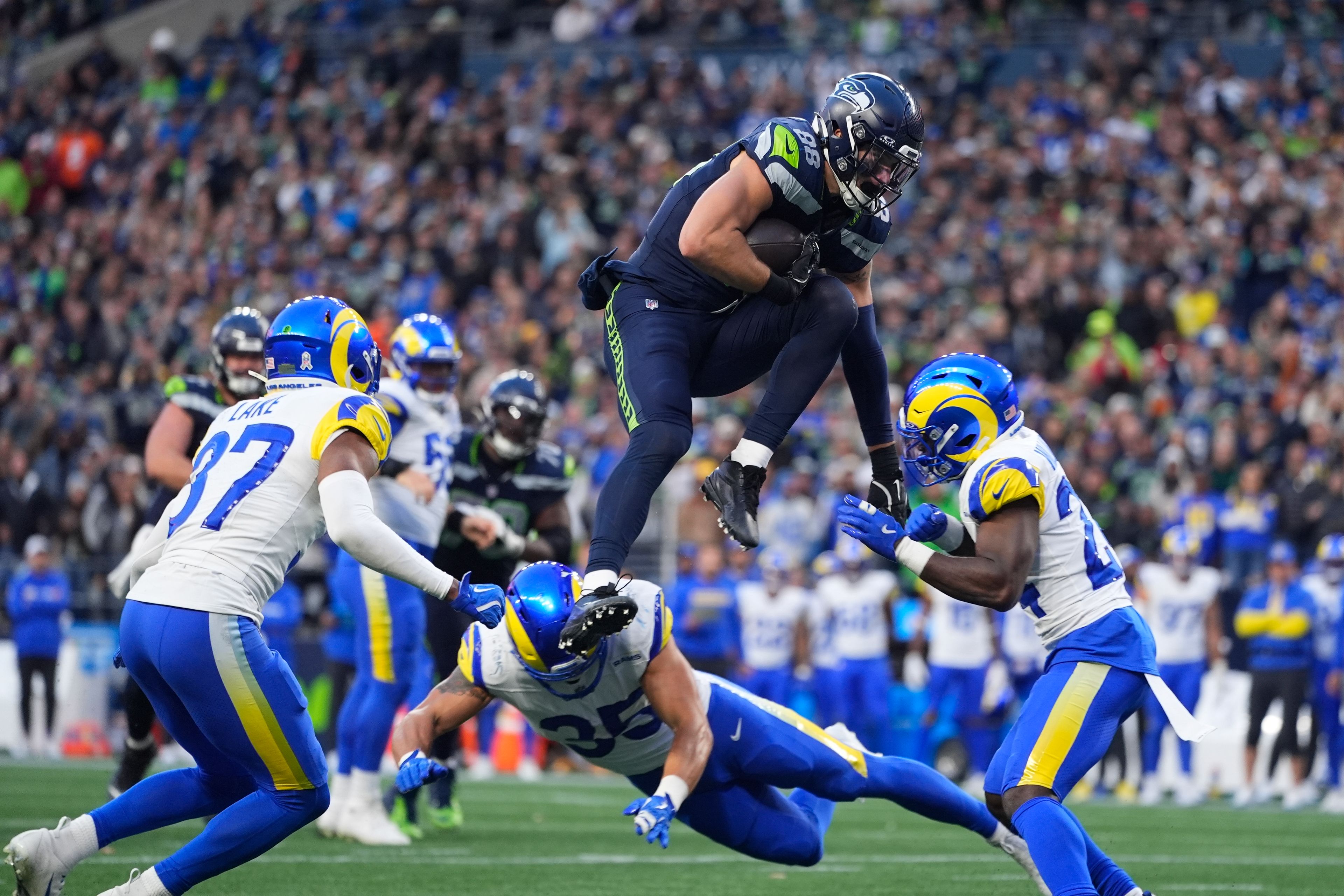 Seattle Seahawks tight end AJ Barner jumps over Los Angeles Rams linebacker Jacob Hummel (35) during an NFL football game, Sunday, Nov. 3, 2024, in Seattle. (AP Photo/Lindsey Wasson)