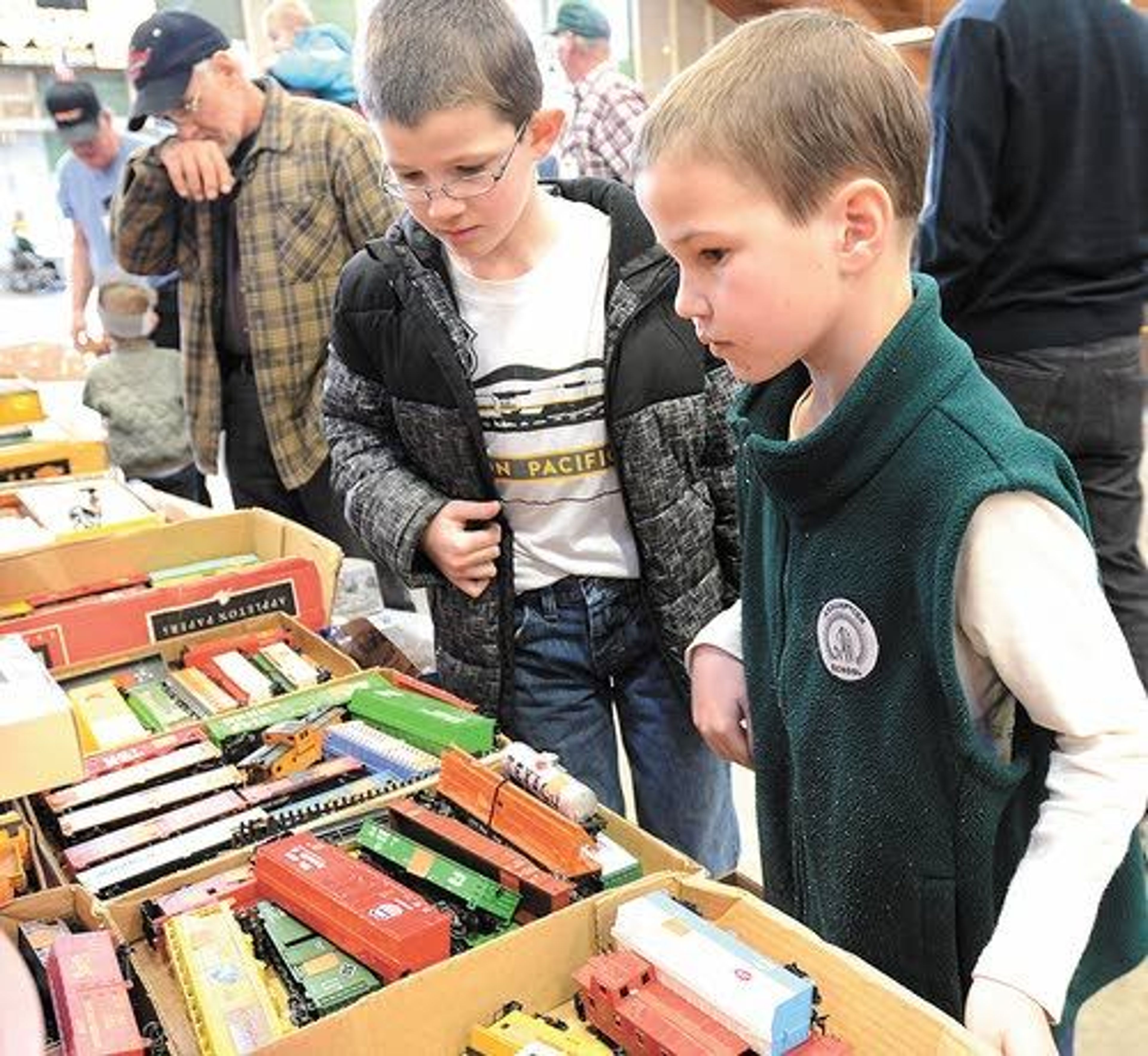 Peter, 9, and James, 8, Didelius of Walla Walla look over the antique train sets on display and for sale during the Lewis-Clark Train Club event Saturday.