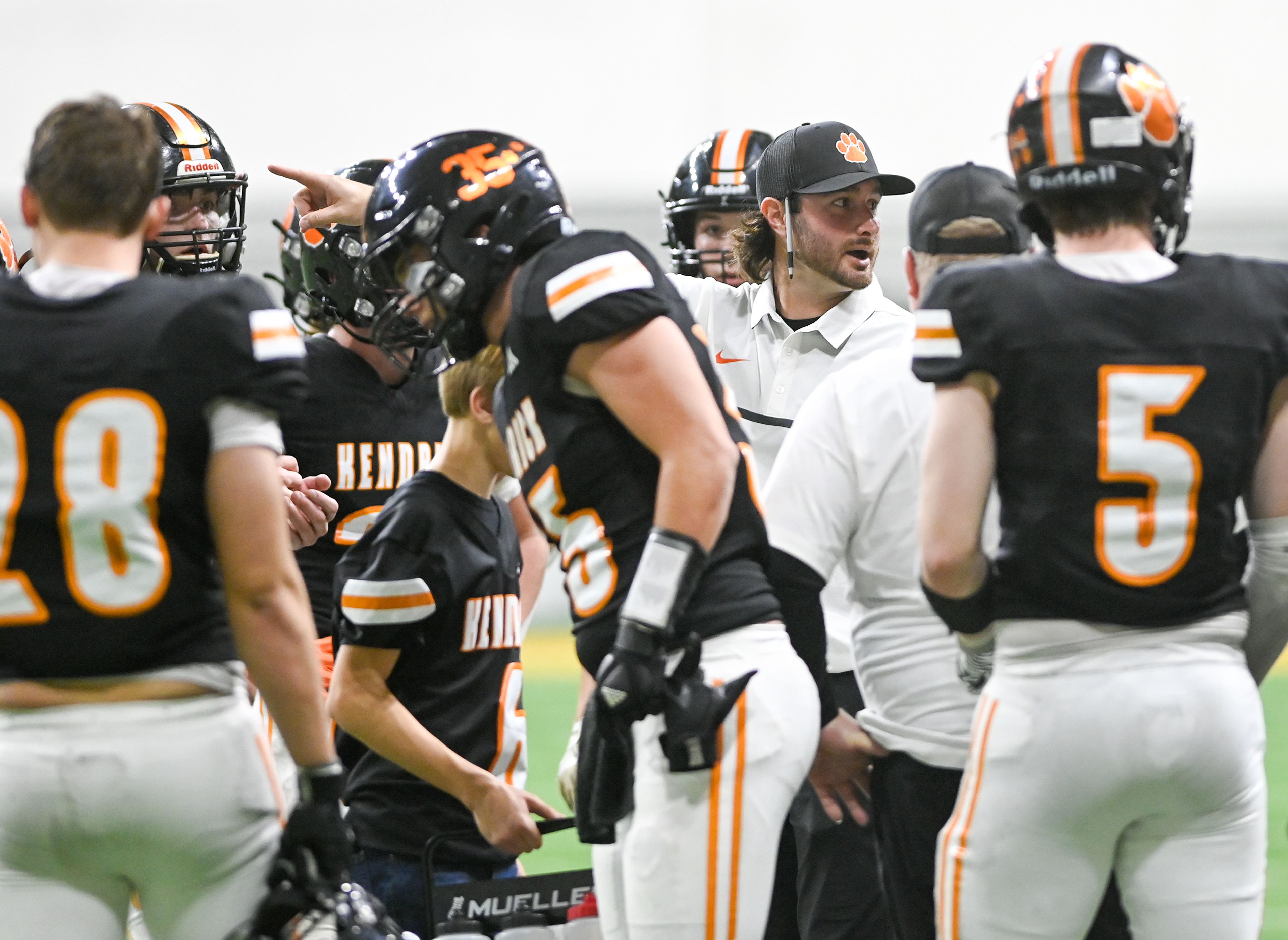 Kendrick head coach Zane Hobart talks to players in a huddle during an Idaho Class 2A state quarterfinal game against Kamiah at the P1FCU Kibbie Dome in Moscow.