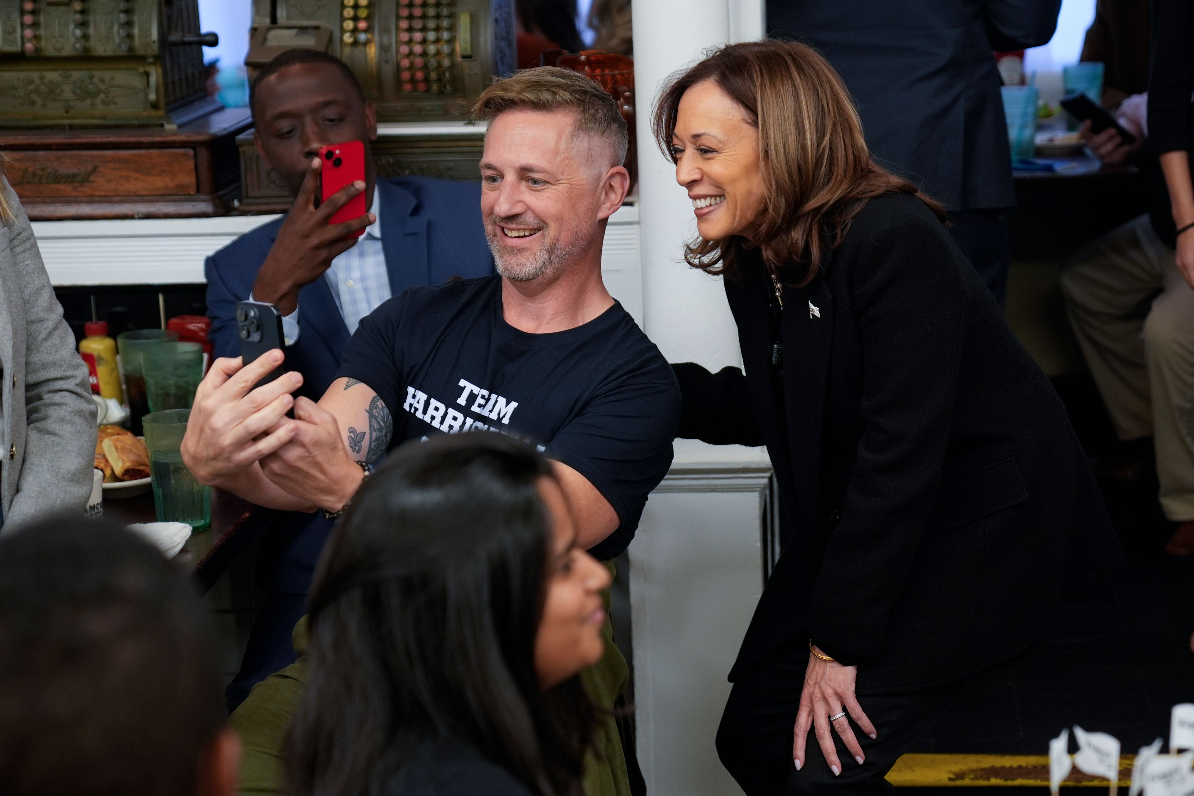 Democratic presidential nominee Vice President Kamala Harris takes a selfie with a patron at a campaign stop at Famous 4th Street Delicatessen in Philadelphia, Wednesday, Oct. 23, 2024. (AP Photo/Matt Rourke)