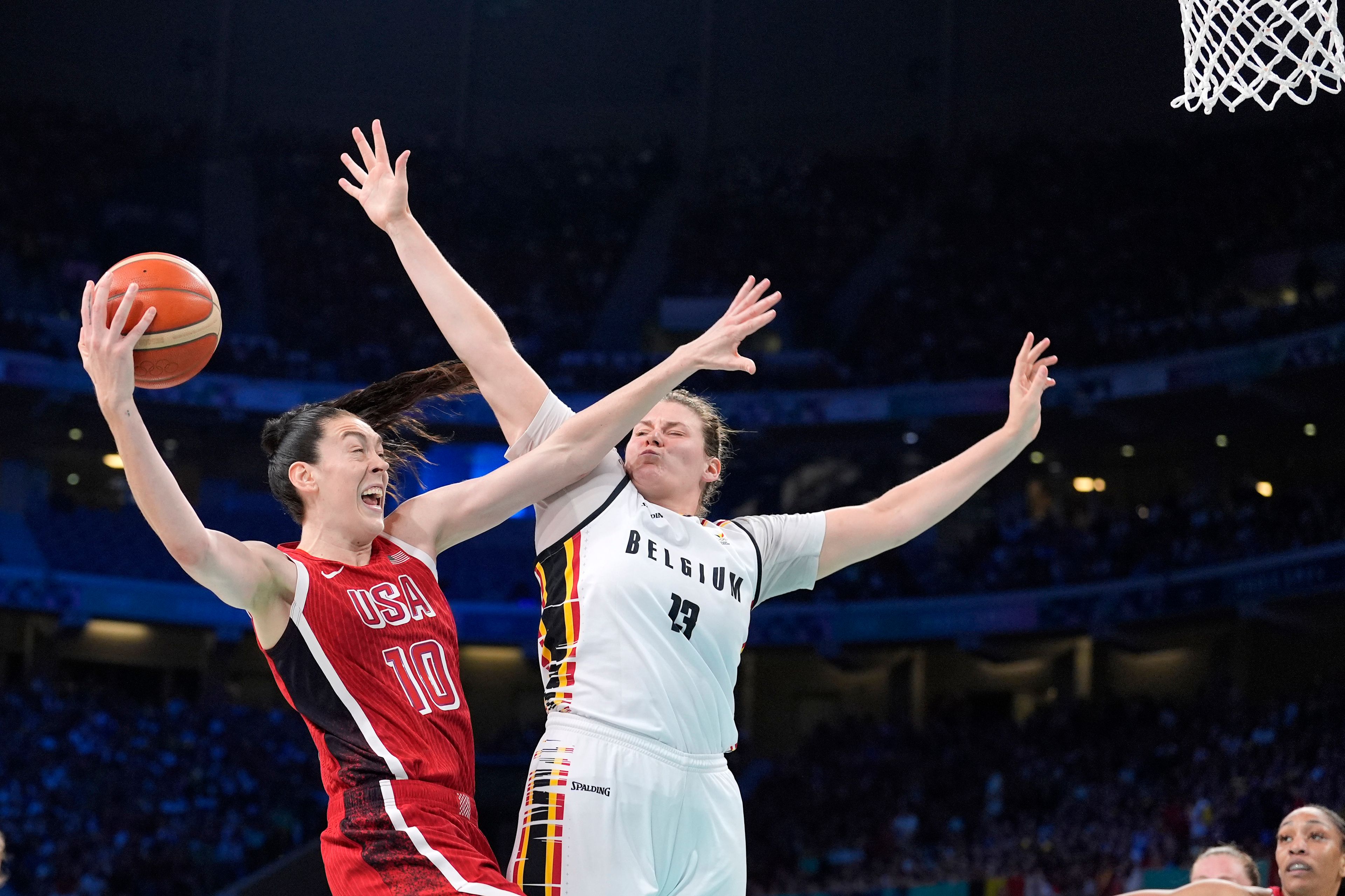 United States' Breanna Stewart, left, shoots as Belgium's Kyara Linskens defends during a women's basketball game at the 2024 Summer Olympics, Thursday, Aug. 1, 2024, in Villeneuve-d'Ascq, France. (AP Photo/Michael Conroy)