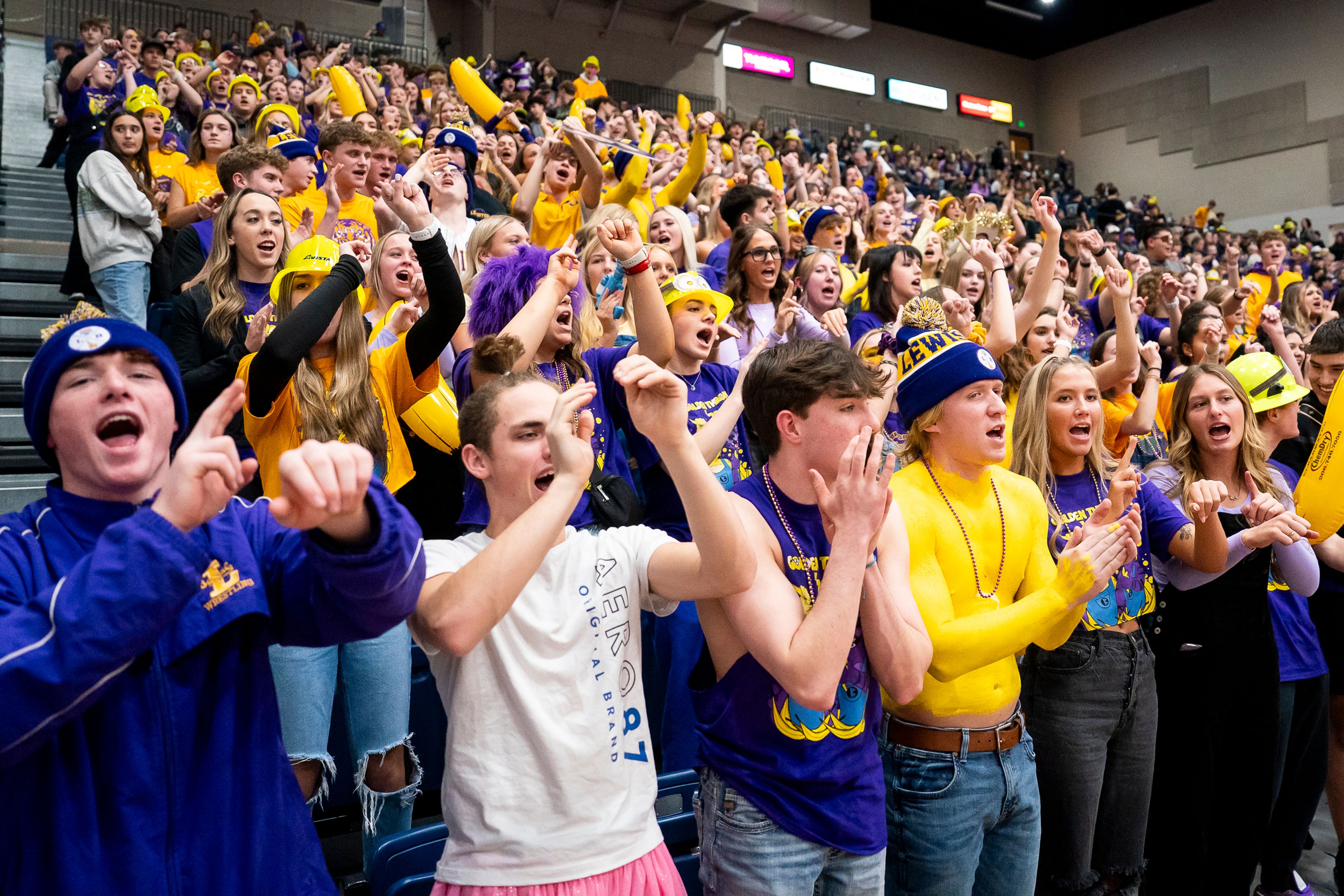 The Lewiston High School student section cheer as their girls basketball team warms up before their Golden Throne rivalry game against Clarkston on Friday inside the P1FCU Activity Center in Lewiston.