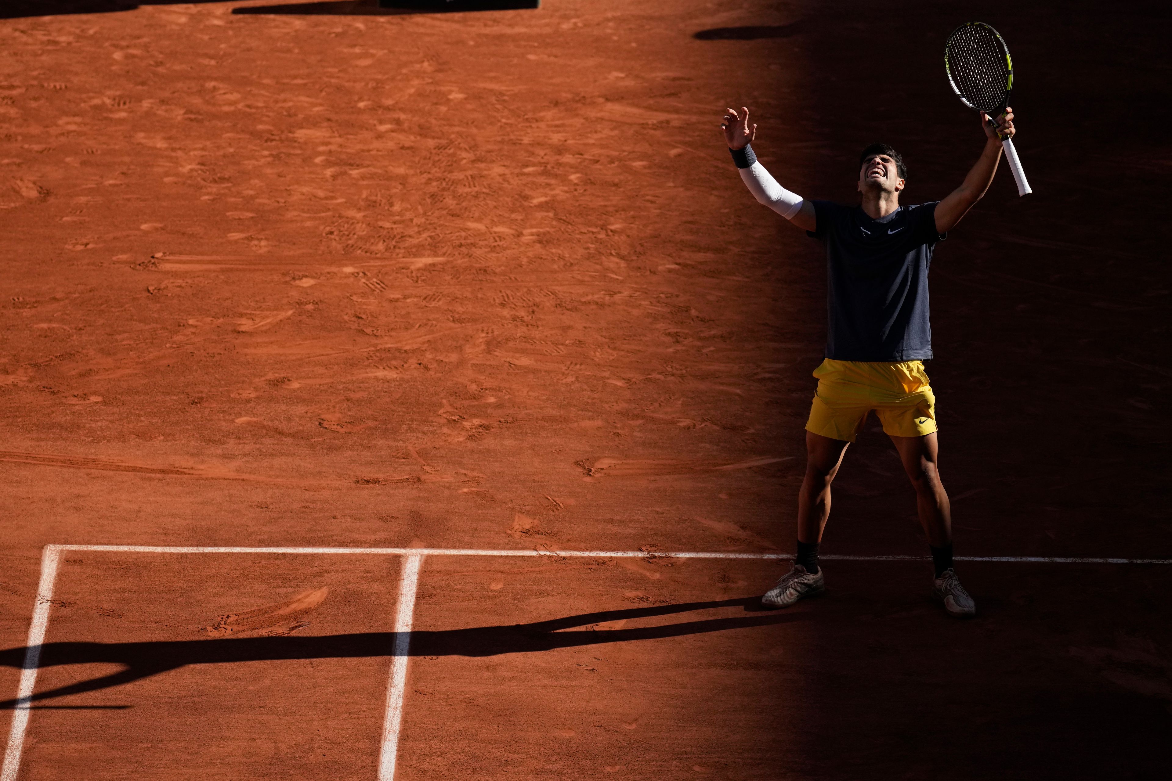 Spain's Carlos Alcaraz celebrates as he won the semifinal match of the French Open tennis tournament against Italy's Jannik Sinner at the Roland Garros stadium in Paris, Friday, June 7, 2024.