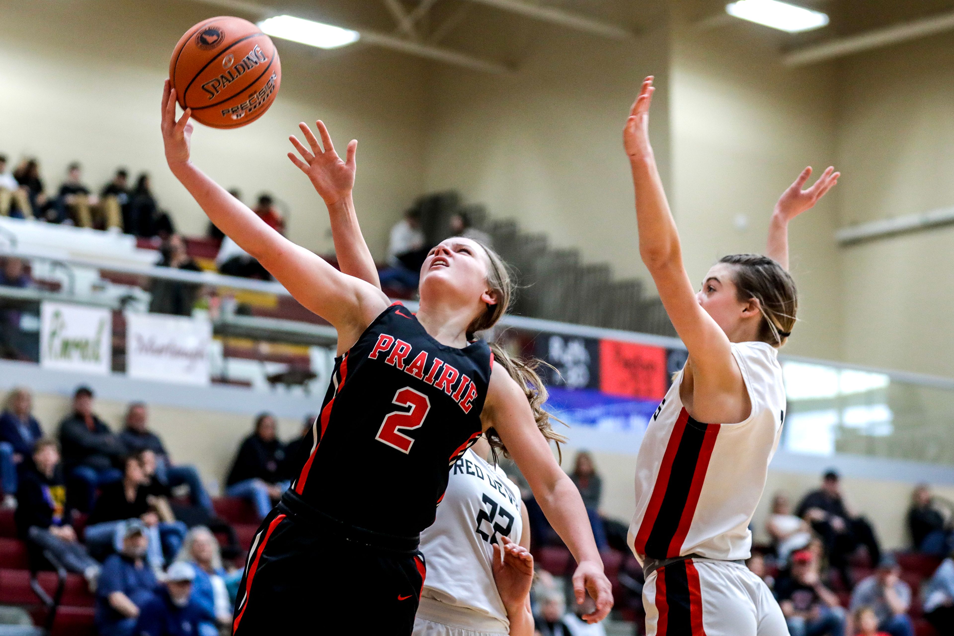 Prairie guard Lexi Schumacher shoots a layup as Murtaugh center Courtney Jensen (22) and forward Ashlee Stanger guard her during a quarterfinal game in the girls 1A DI state tournament Thursday at Columbia High School in Nampa.