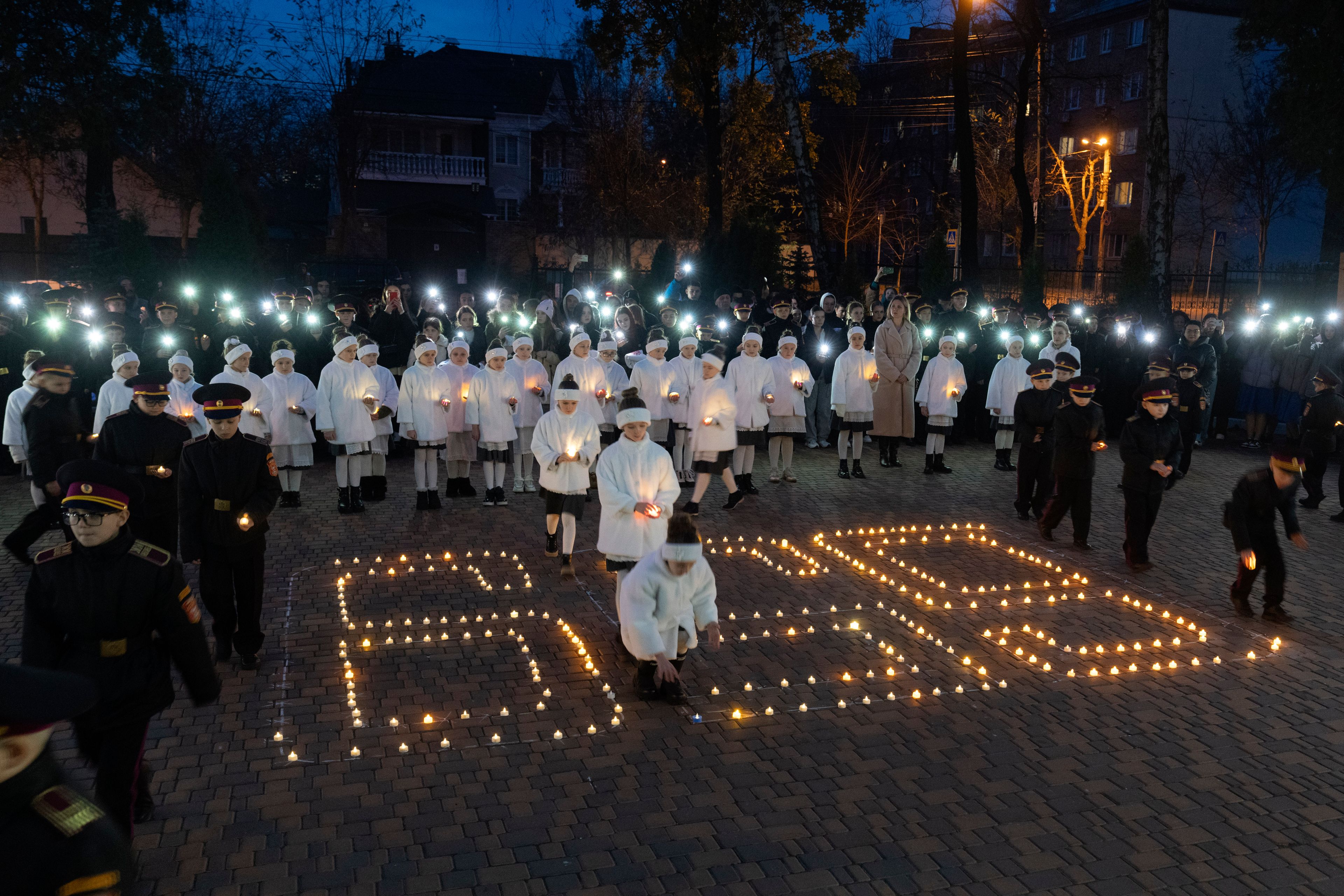 Cadets light candles in a 659 shape, the number of Ukrainian children killed in the war with Russia, in a military lyceum on World Children's Day in Kyiv, Ukraine, Wednesday, Nov. 20, 2024. (AP Photo/Efrem Lukatsky)