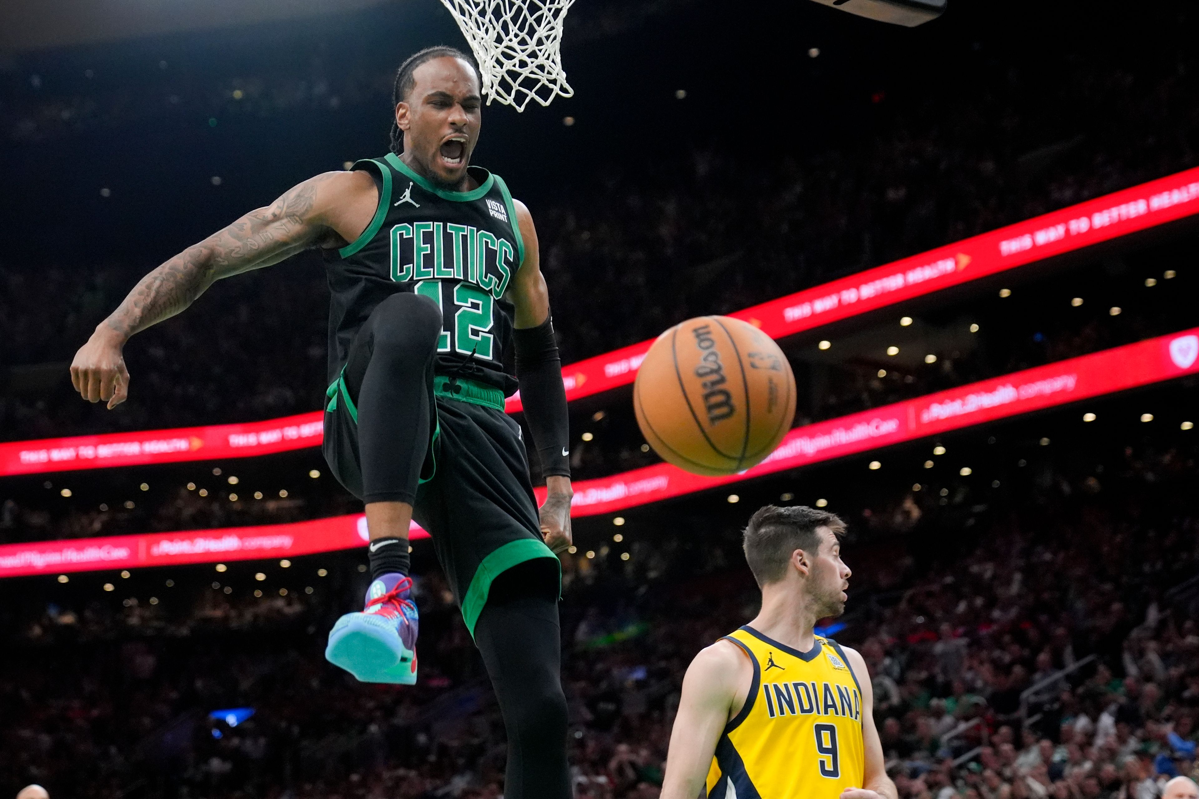 Celtics forward Oshae Brissett, left, celebrates after dunking against the Pacers during the second half of Game 2 of the Eastern Conference finals Thursday in Boston.