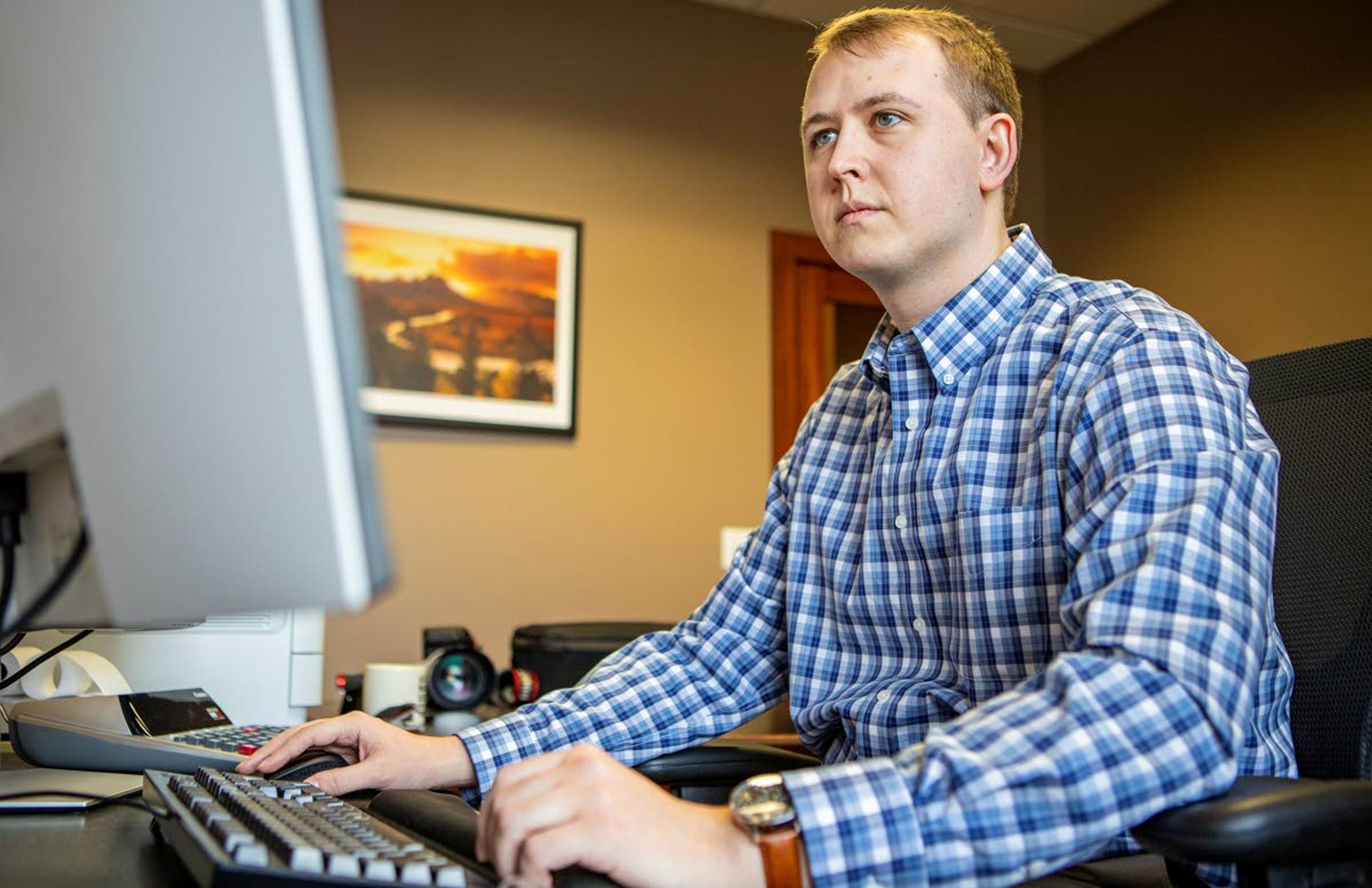 Accountant Caleb Latella of Jurgens & Co. in Lewiston looks up the prices of homes listed in his area on Friday at his office. Latella, who was frustrated by his fruitless search for a home, took the step of putting out a call on Facebook for leads.