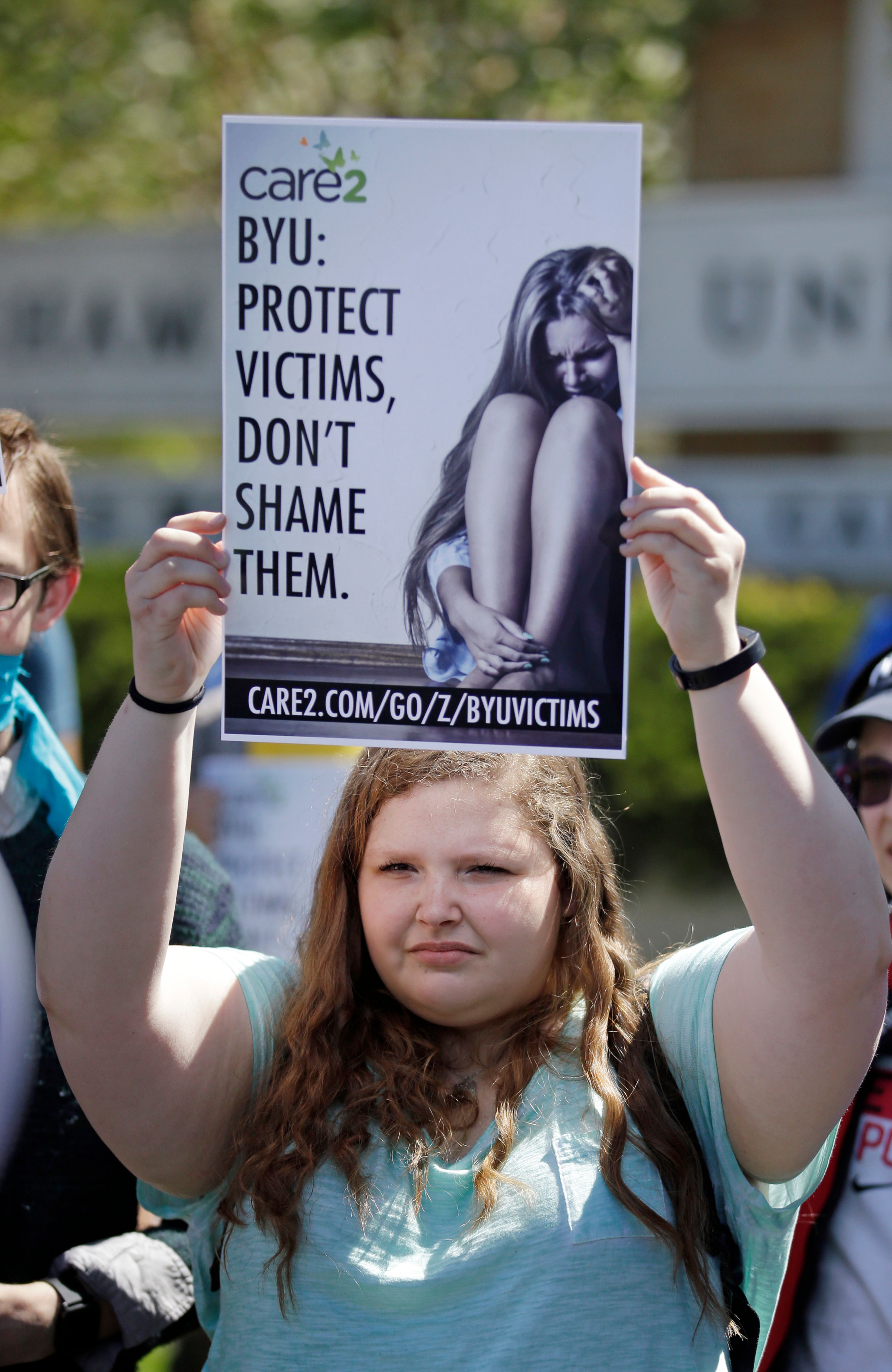 FILE - A protester stands in solidarity with rape victims on the campus of Brigham Young University during a sexual assault awareness demonstration Wednesday, April 20, 2016, in Provo, Utah. (AP Photo/Rick Bowmer, File)