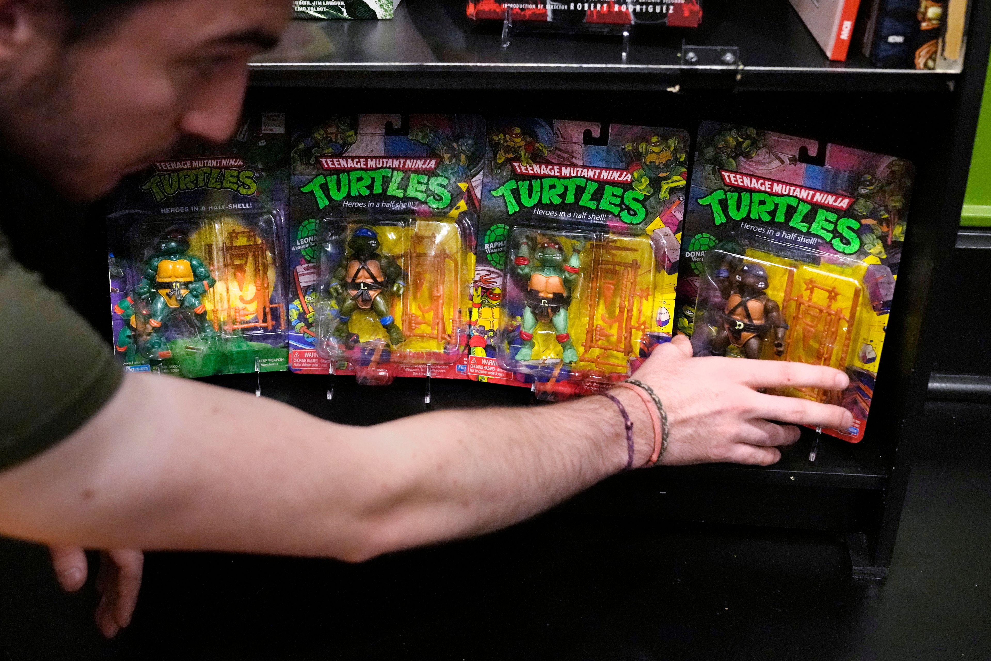 John Cookson, operations manager at the Woodman Museum, shows first edition Teenage Mutant Ninja Turtles action figures, which are part of the museum's permanent collection, Thursday, Sept. 5, 2024, in Dover, N.H.