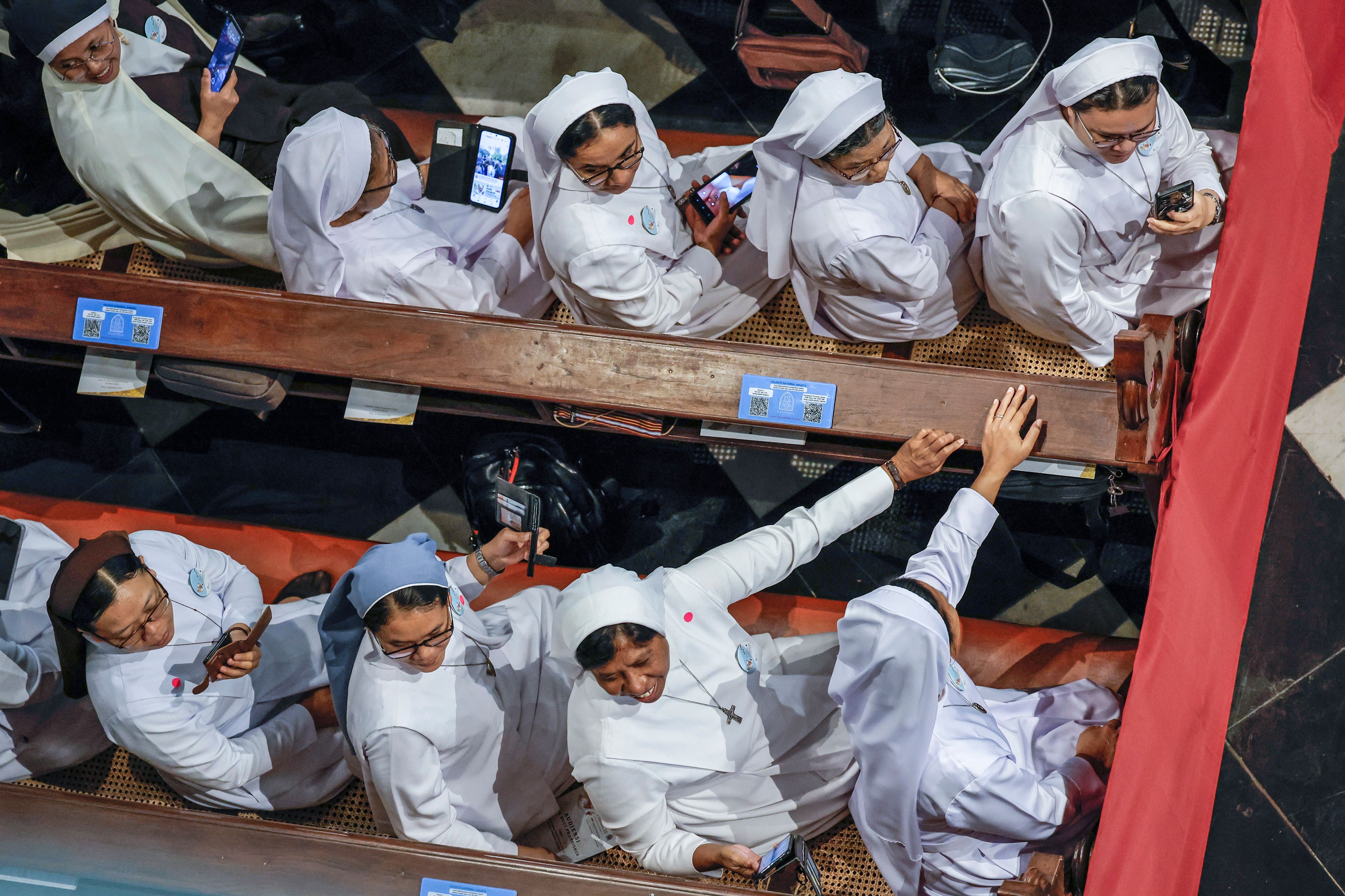 Nuns wait for the arrival of Pope Francis at the Jakarta Cathedral in Jakarta, Indonesia, Wednesday, Sept. 4, 2024.