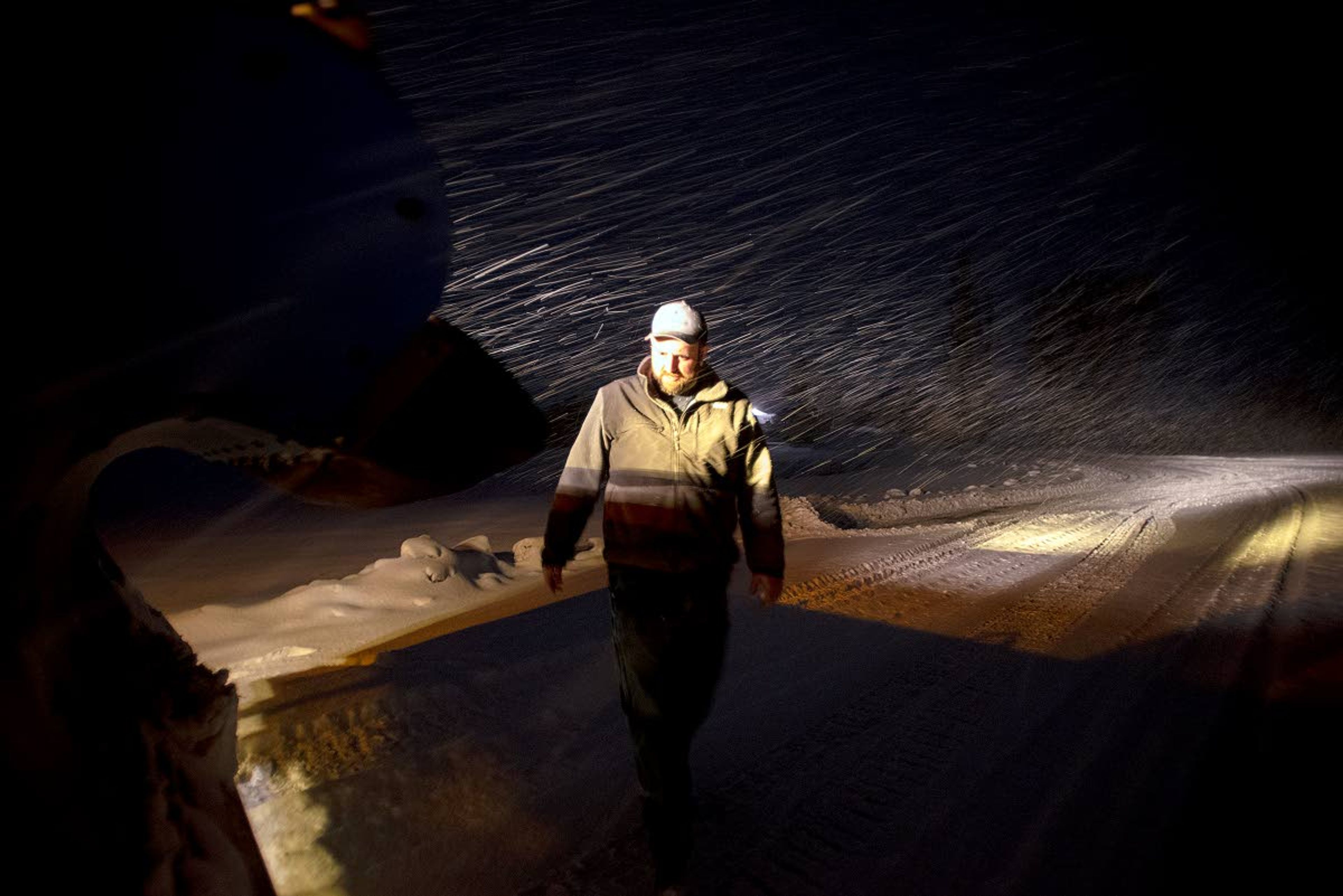 After about an hour of clearing snow off of the gravel roads northeast of Genesee, Cody Bailey checks the front end of his plow to make sure everything is working properly Wednesday morning.