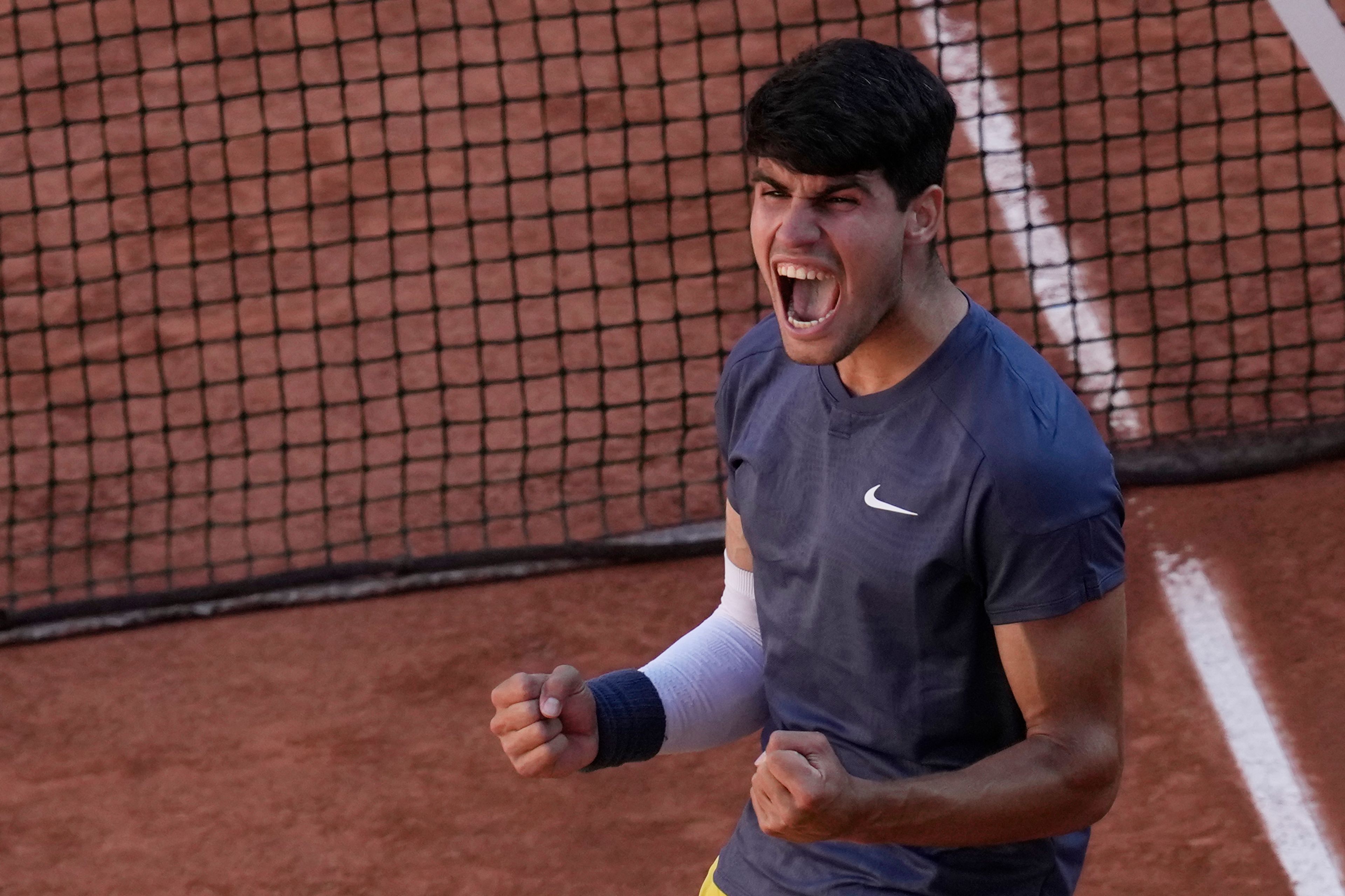 Spain's Carlos Alcaraz celebrates as he won the semifinal match of the French Open tennis tournament against Italy's Jannik Sinner at the Roland Garros stadium in Paris, Friday, June 7, 2024.