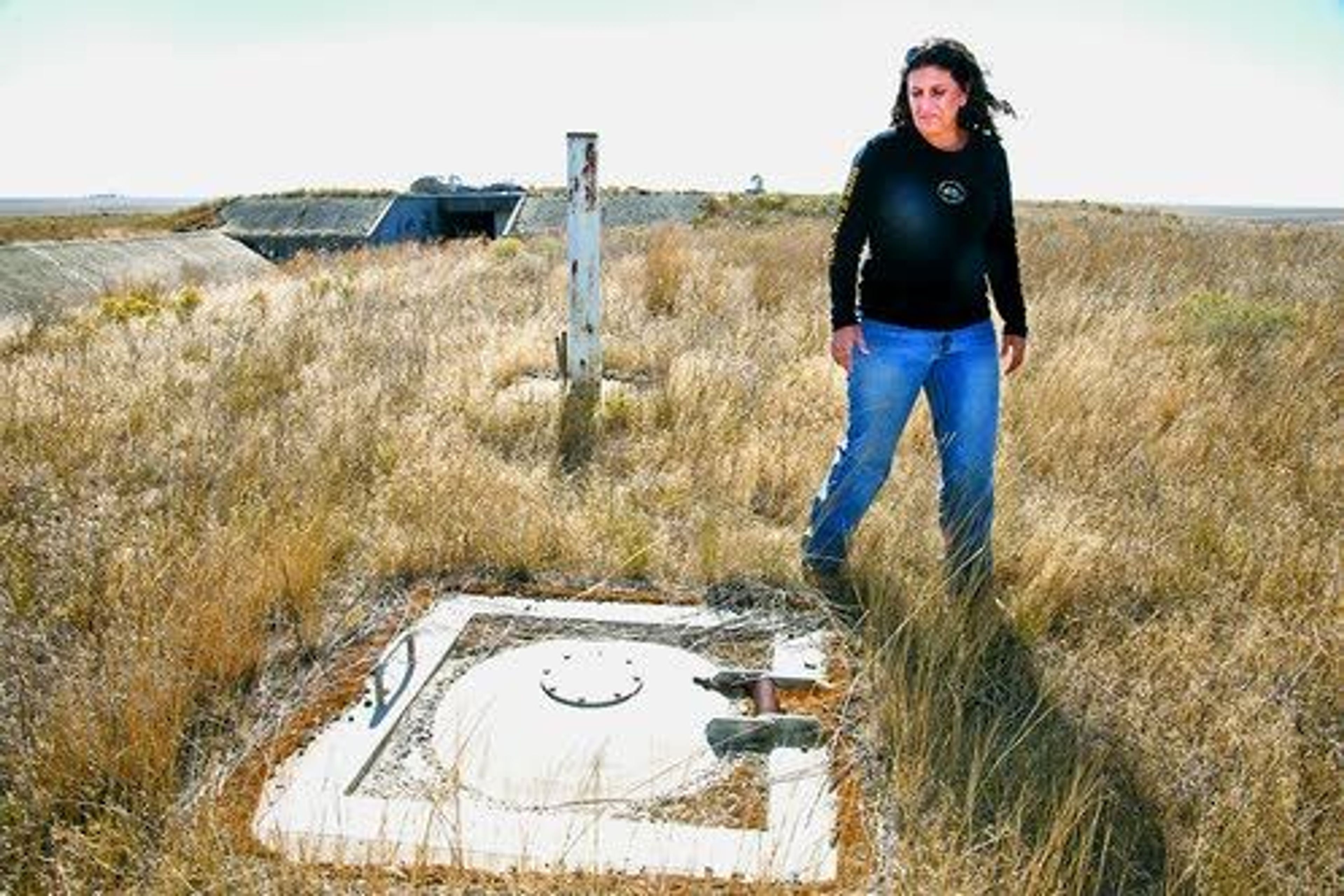 Teri Kramer points out an escape hatch over the living quarters of a former Atlas long-range ballistic missile site, one of nine underground Atlas sites in eastern Washington, near Lamona, Wash., on the Kramer family’s 20-acre site.