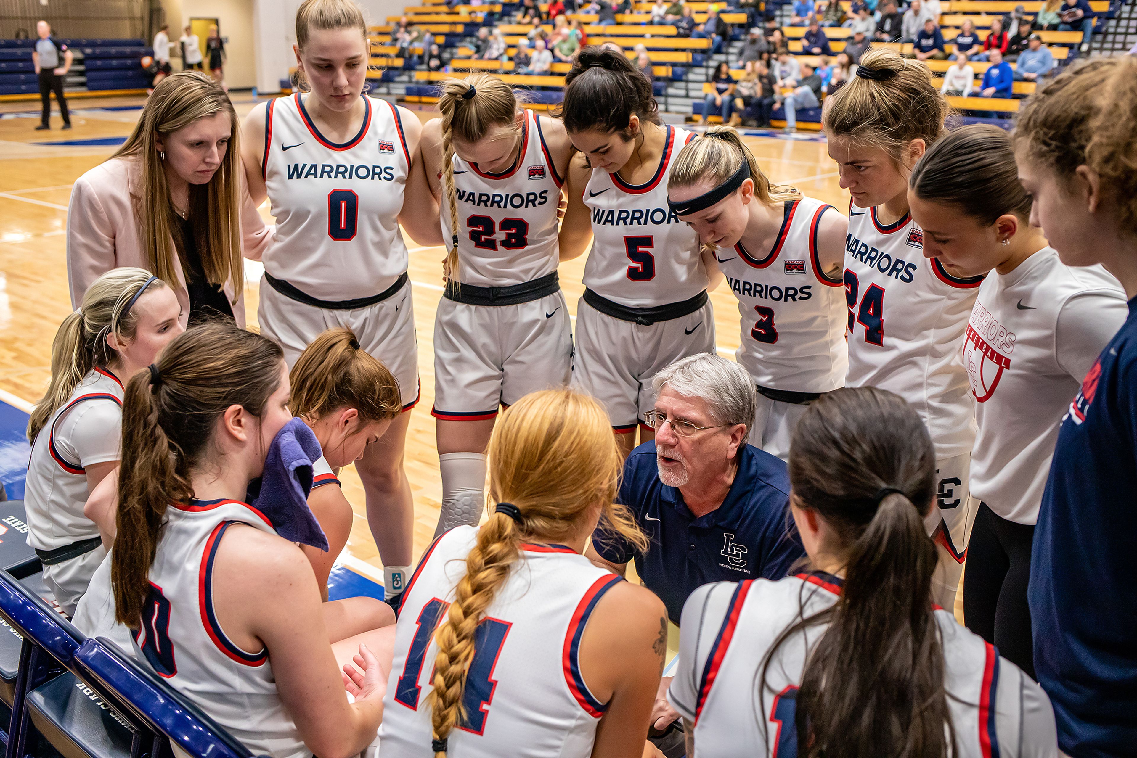 Coach Brian Orr talks strategy with his team during a timeout during Saturday's Cascade Conference game against Southern Oregon at the P1FCU Activity Center.