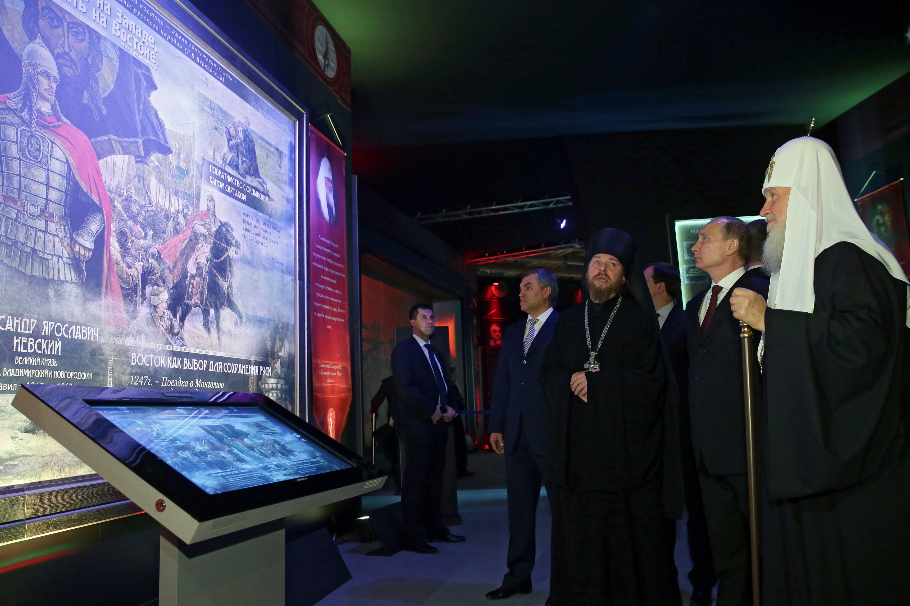 FILE - Russian President Vladimir Putin, second right, Russian Orthodox Patriarch Kirill, right, First Deputy Chief of Staff of the Presidential Administration Vyacheslav Volodin, fourth right, and Archimandrite Tikhon Shevkunov, third right, visit the exhibition "Orthodox Russia, My History, The Rurik Dynasty" at Manezh Exhibition Hall during celebration of the National Unity Day in Moscow, Russia, Tuesday, Nov. 4, 2014. In Russia, history has long become a propaganda tool used to advance the Kremlin's political goals. In an effort to rally people around the flag, the authorities have sought to magnify the country's past victories while glossing over the more sordid chapters of its history. (Mikhail Metzel, Sputnik, Kremlin Pool Photo via AP, File)