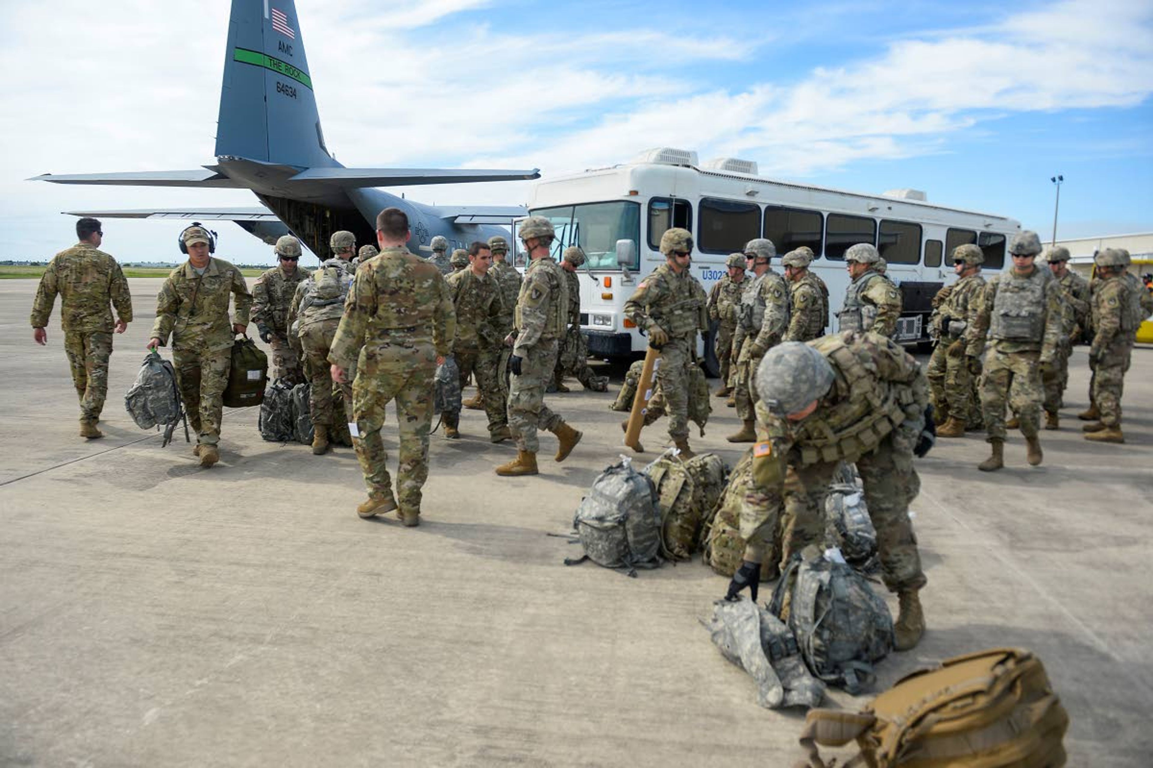 In this photo provided by the U.S. Air Force, soldiers from the the 89th Military Police Brigade, and 41st Engineering Company, 19th Engineering Battalion, Fort Riley, Kan., arrive at Valley International Airport, Thursday, Nov. 1, 2018, in Harlingen, Texas, to conduct the first missions along the southern border in support of Operation Faithful Patriot. The soldiers will provide a range of support including planning assistance, engineering support, equipment and resources to assist the Department of Homeland Security along the Southwest border. (Alexandra Minor/U.S. Air Force via AP)