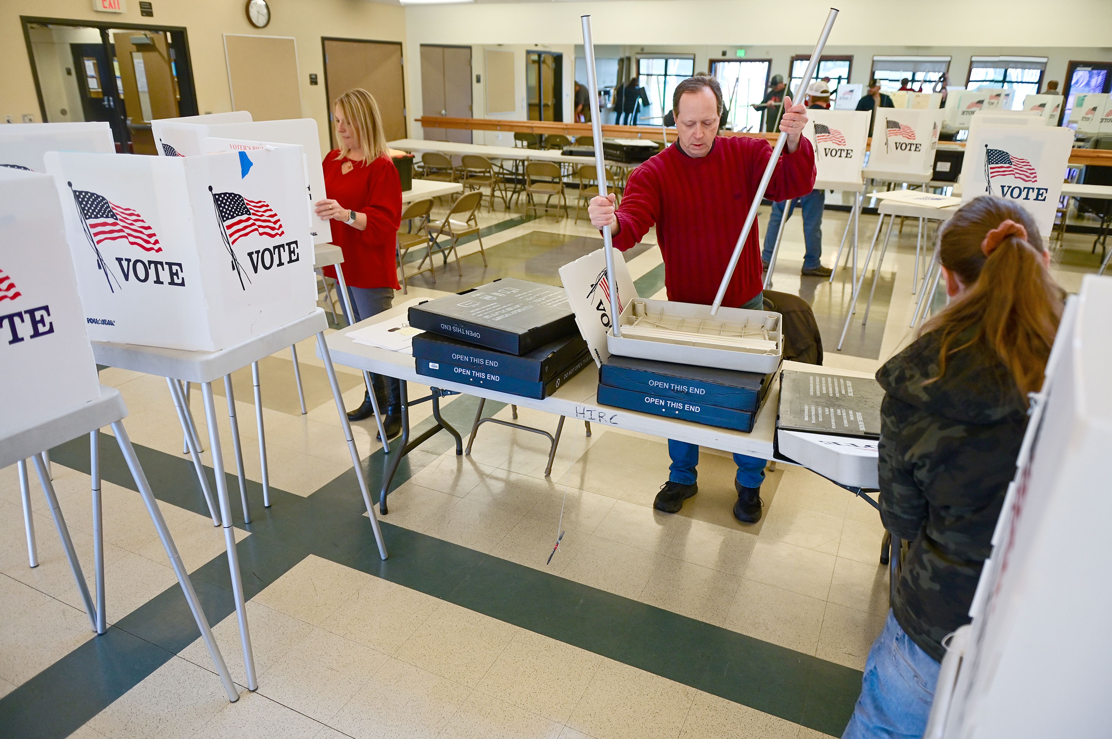 Scott Janke, center, a poll worker for Election Day, helps build polling booths at the Hamilton Indoor Recreation Center, a polling location for Latah County, in Moscow.