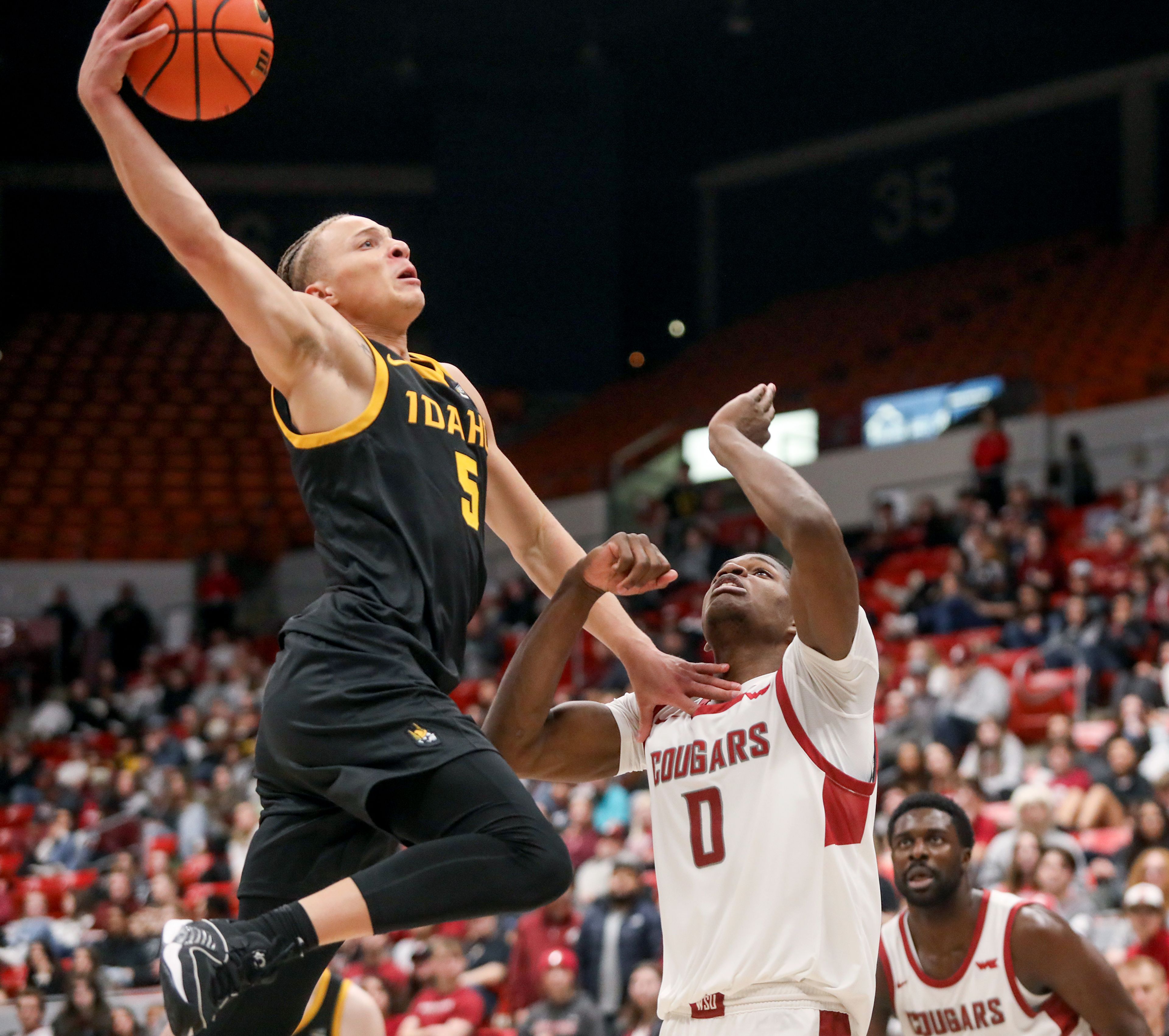 Idaho guard Isaiah Brickner jumps with a hand on Washington State guard Cedric Coward to attempt a two-point shot Monday during the Battle of the Palouse game at Beasley Coliseum in Pullman.