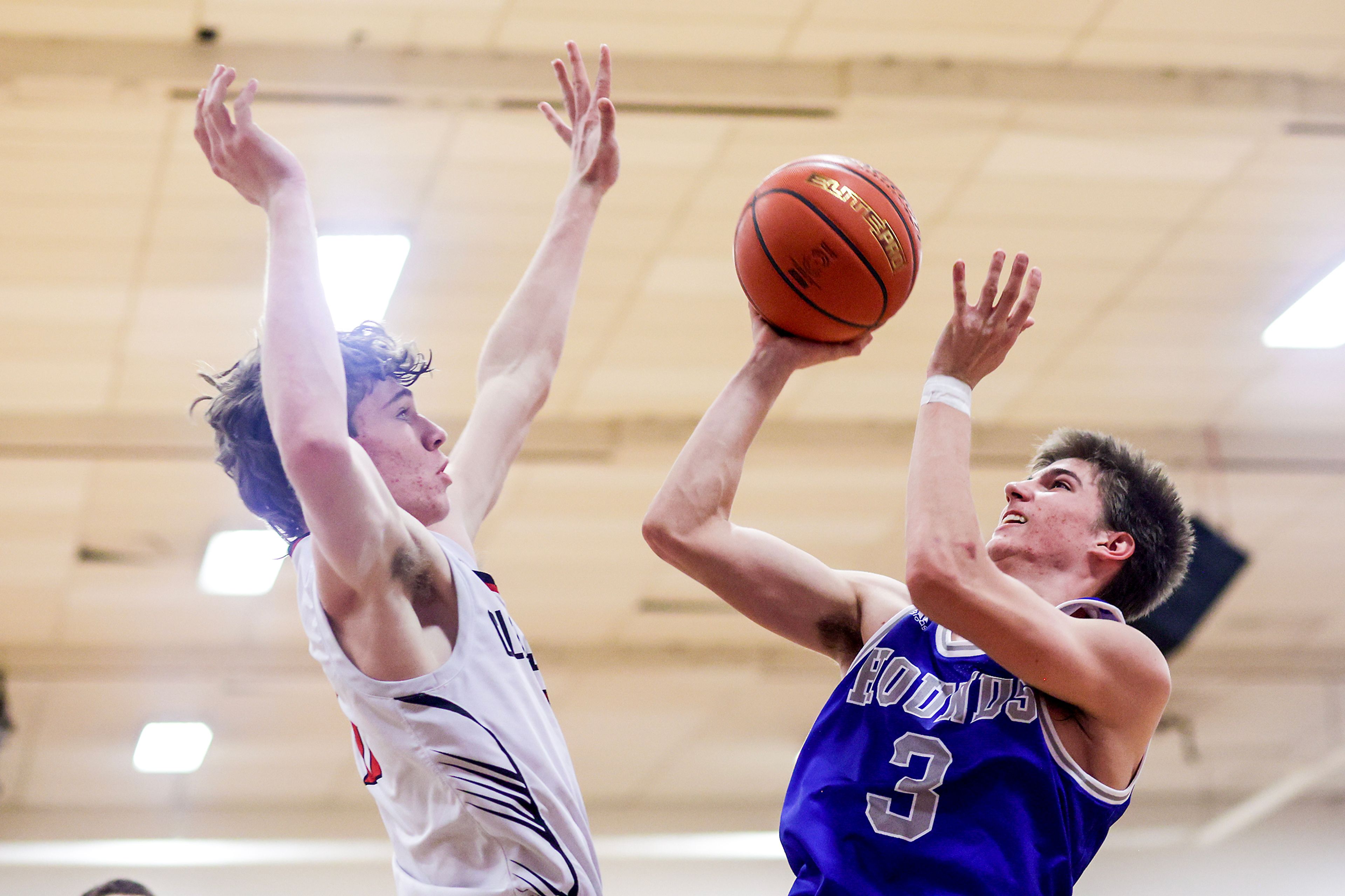 Pullman shooting guard Tanner Barbour, right, shoots the ball as Clarkston forward Dustin Beck defends during Tuesday's Class 2A Greater Spokane League boys basketball game.