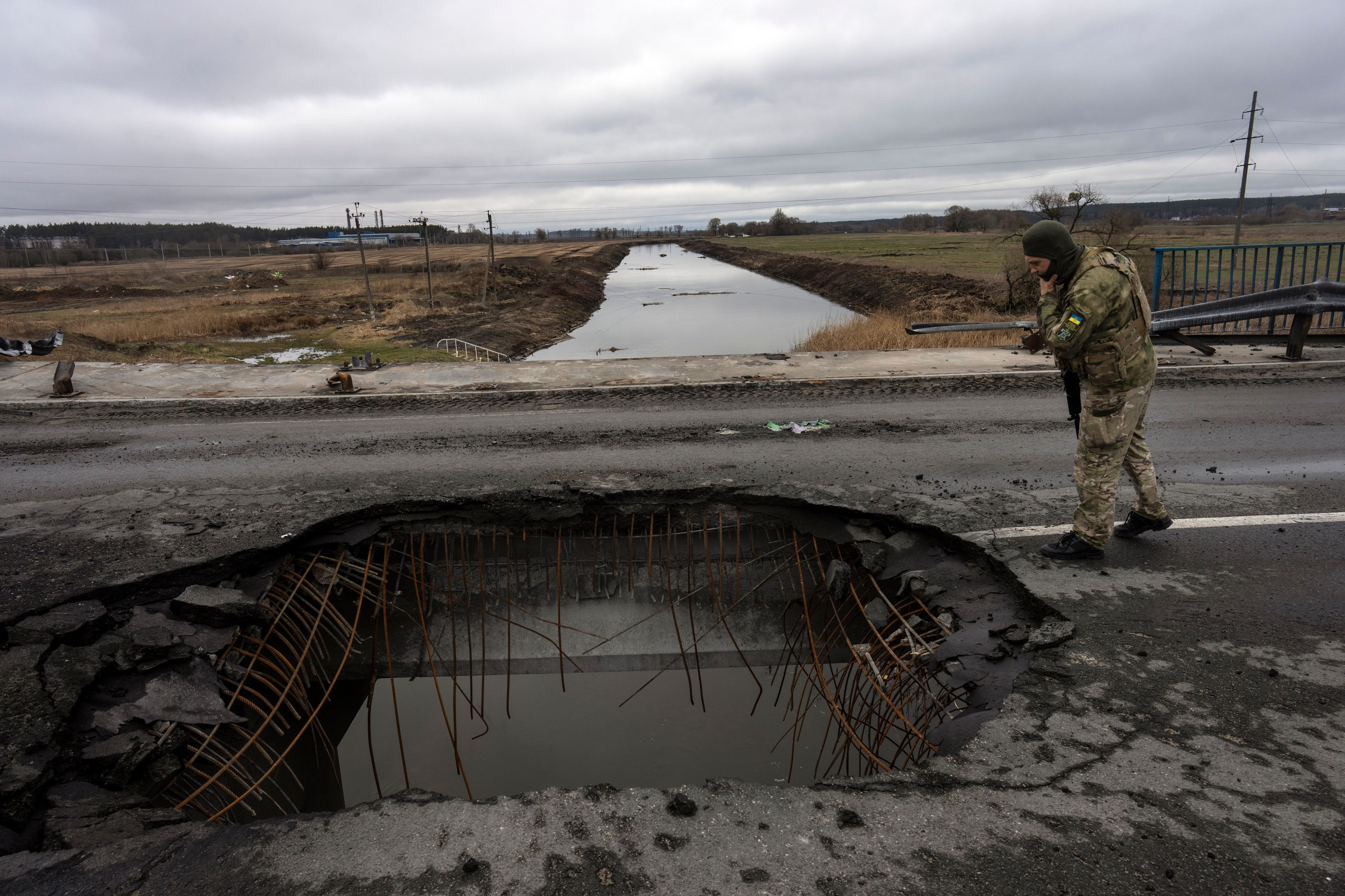 A Ukrainian soldier looks at a damaged bridge in Bucha, on the outskirts of Kyiv, Ukraine, Saturday, April 2, 2022. As Russian forces pull back from Ukraine’s capital region, retreating troops are creating a “catastrophic" situation for civilians by leaving mines around homes, abandoned equipment and “even the bodies of those killed," President Volodymyr Zelenskyy warned Saturday. (AP Photo/Rodrigo Abd)